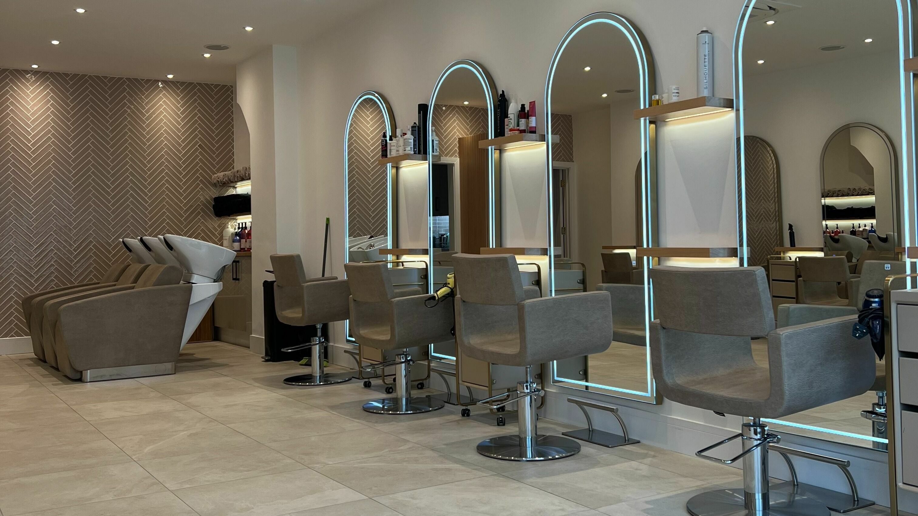 Modern interior of Elysia Valentina Hair Studio featuring stylish salon chairs in London, England, GB.
