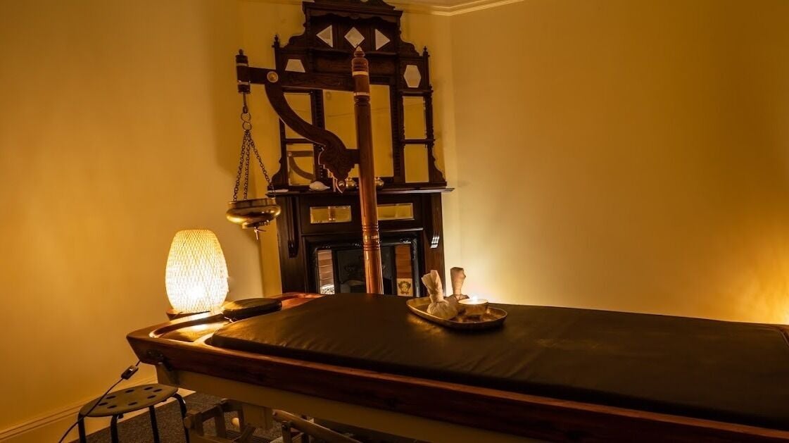 Tranquil Ayurvedic treatment room at Liv Ayurveda Parramatta, New South Wales, AU with ambient lighting.