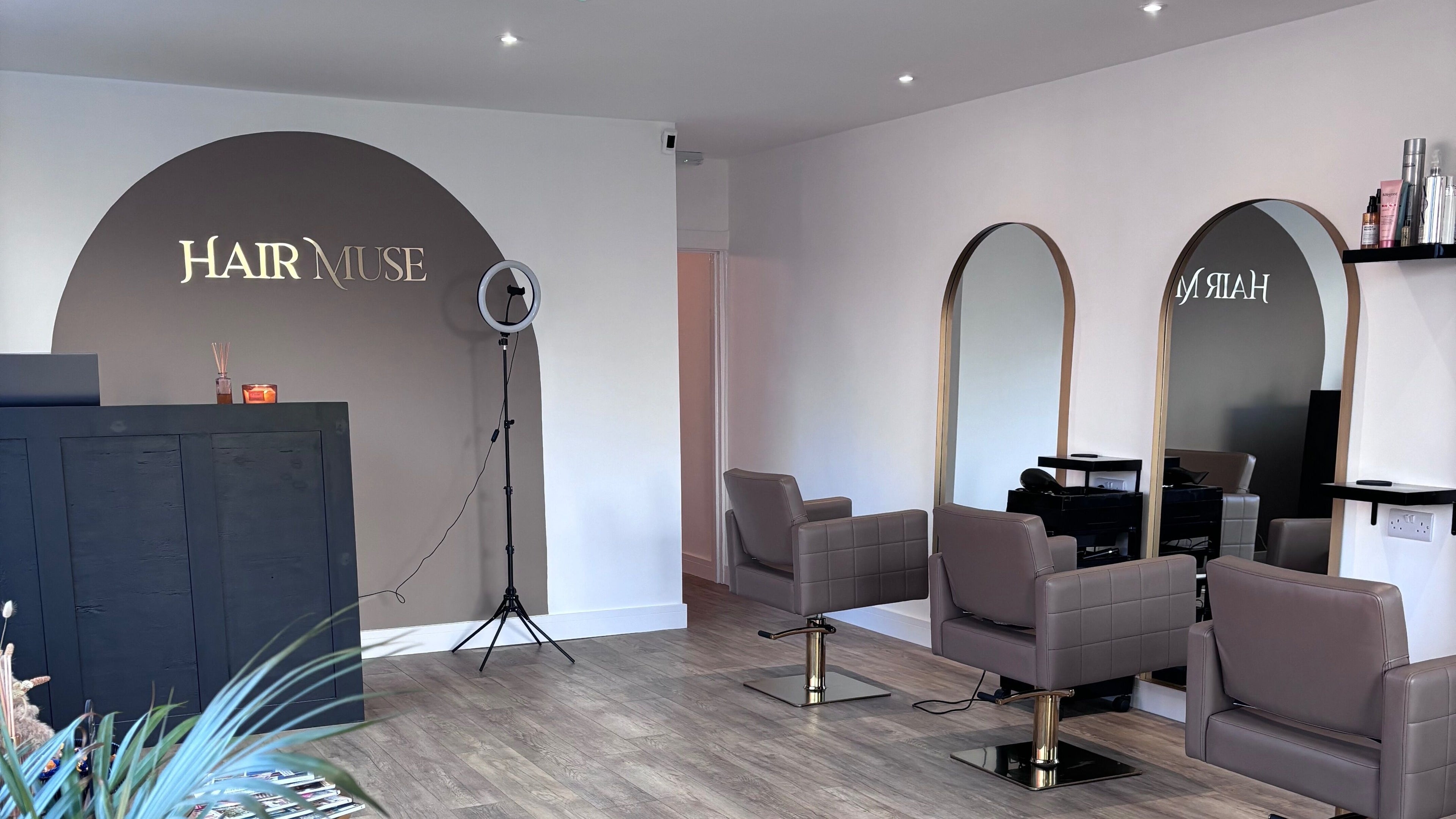 Interior of Hair Muse salon in Leicester, England, GB featuring modern styling chairs and elegant mirrors.
