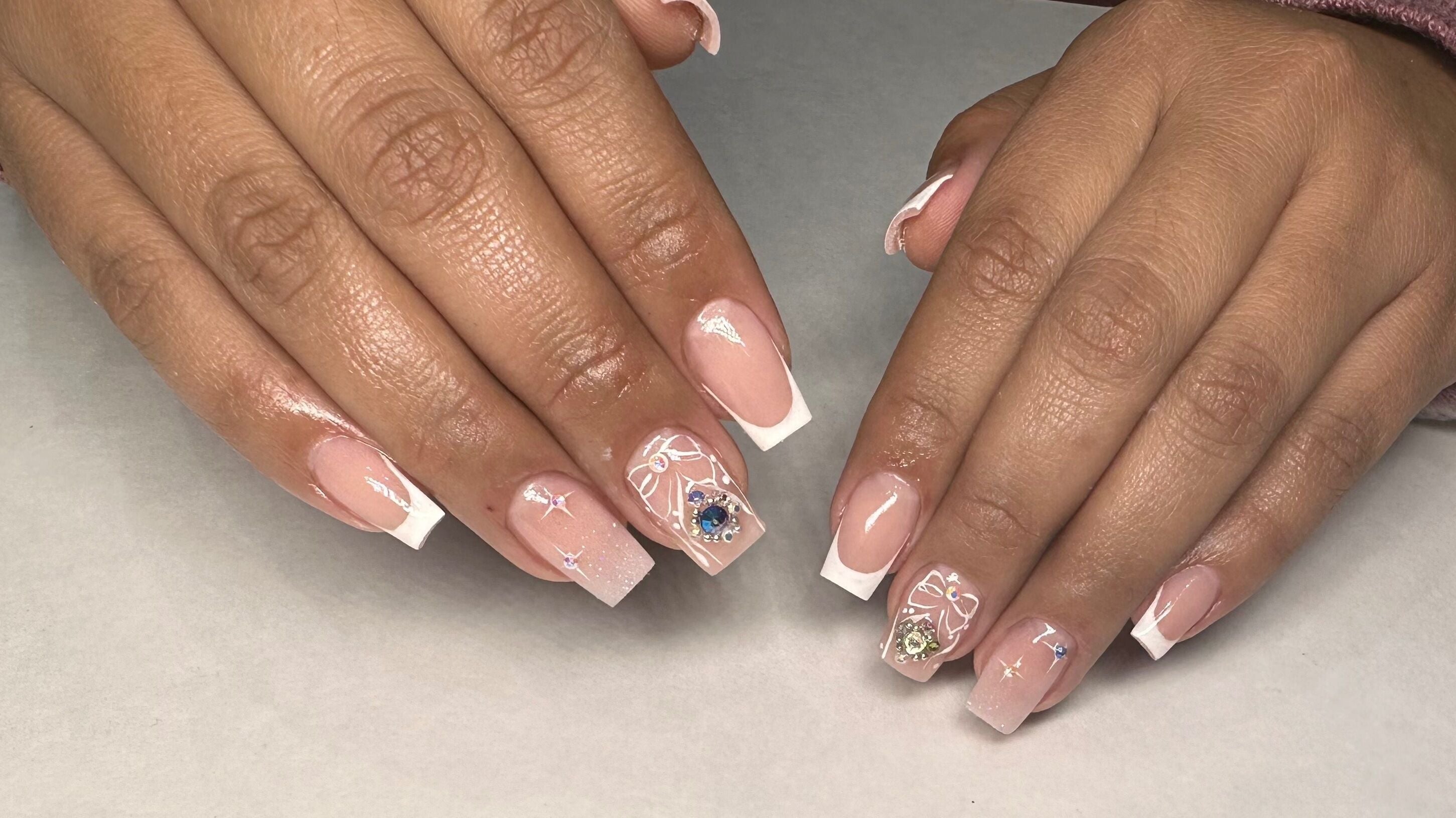 Intricate nail design at Valley Ridge Nail Salon in Calgary, Alberta, CA featuring elegant, rhinestone-adorned nails.