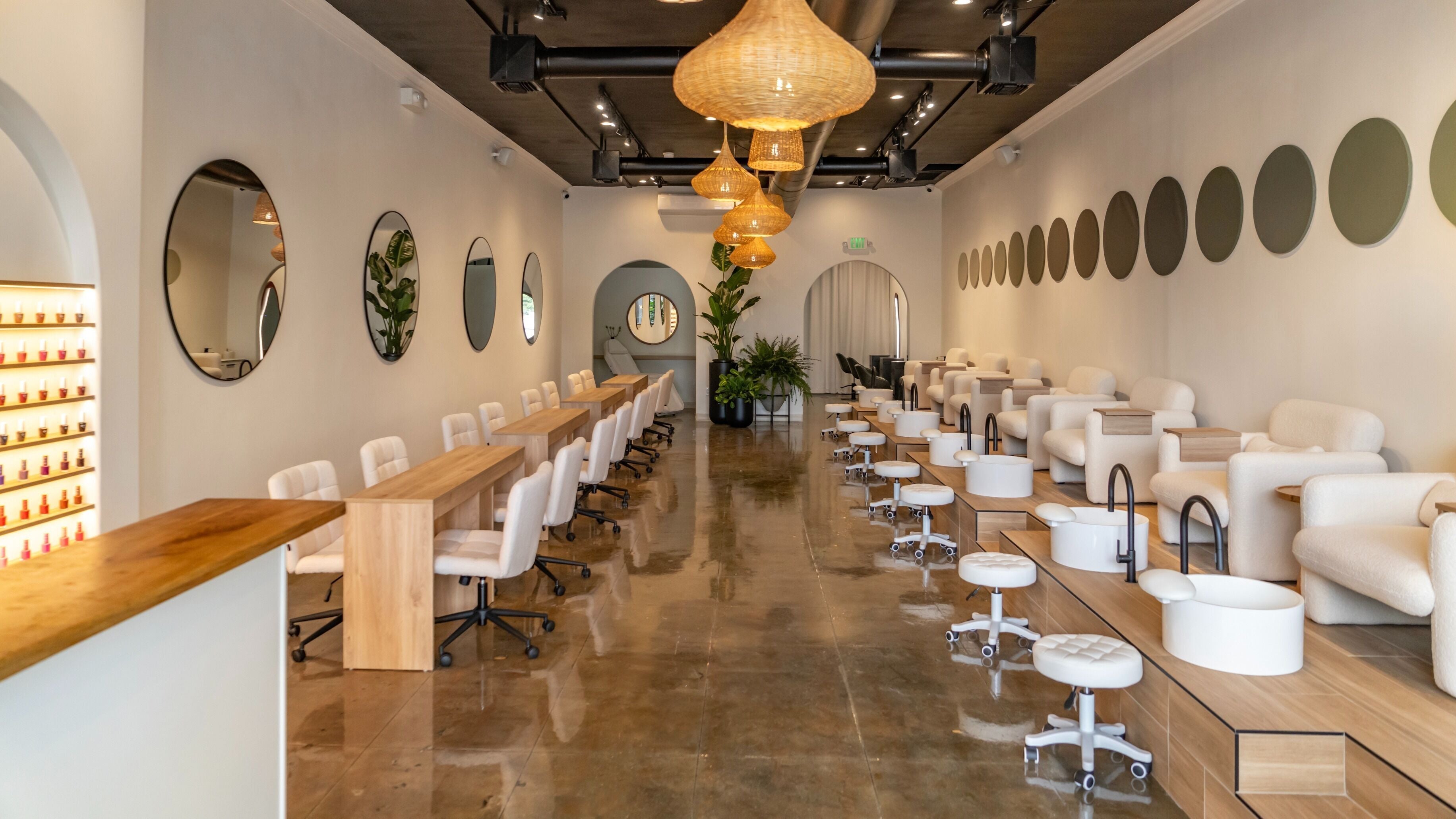 Interior view of Charme Nails & Beauty featuring modern decor and seating in Los Angeles, California, US.