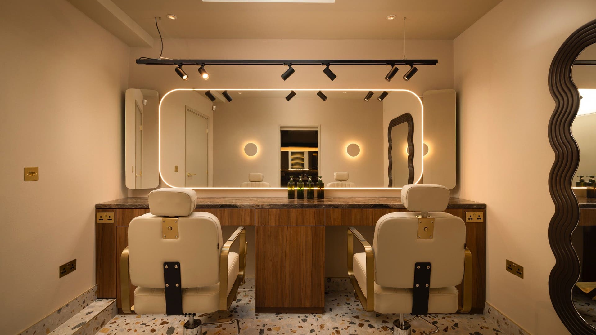 About YU salon interior with chic mirrors and plush chairs in London, England, GB.