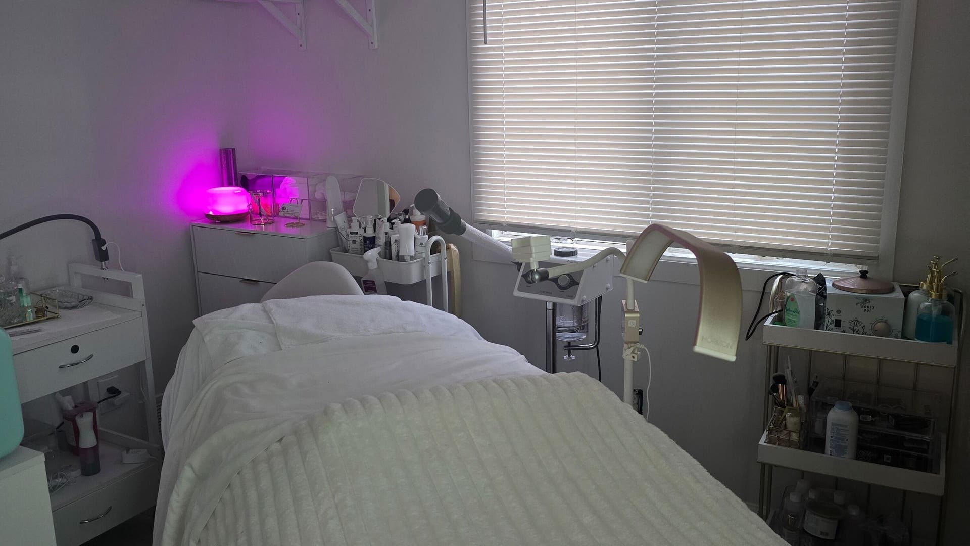 Relaxing treatment room at PalomaBeautyGlow, Brentwood, New York, US with modern equipment and ambient lighting.