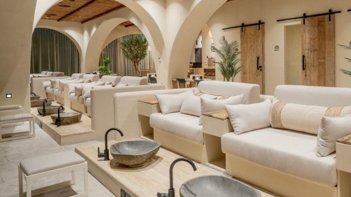 Luxurious pedicure lounge at Yoush Spa, Riyadh, Riyadh Province, SA with plush seating and natural decor.