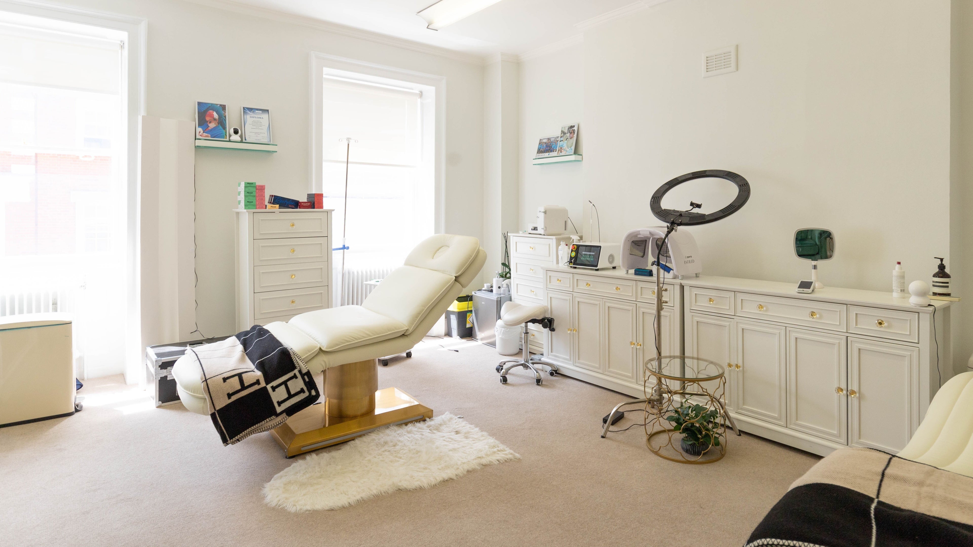 Spacious treatment room at Aiia Clinic in London, England, GB with modern equipment and elegant furnishings.