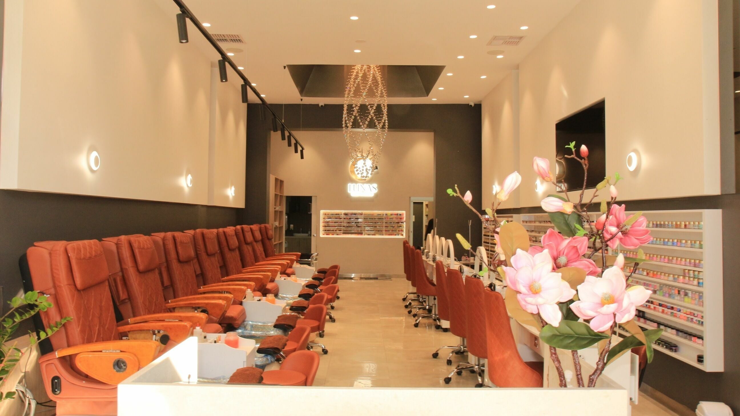 Interior of LUNAS NAILS & LASHES in Melbourne, Victoria, AU, featuring plush seating and floral decor.
