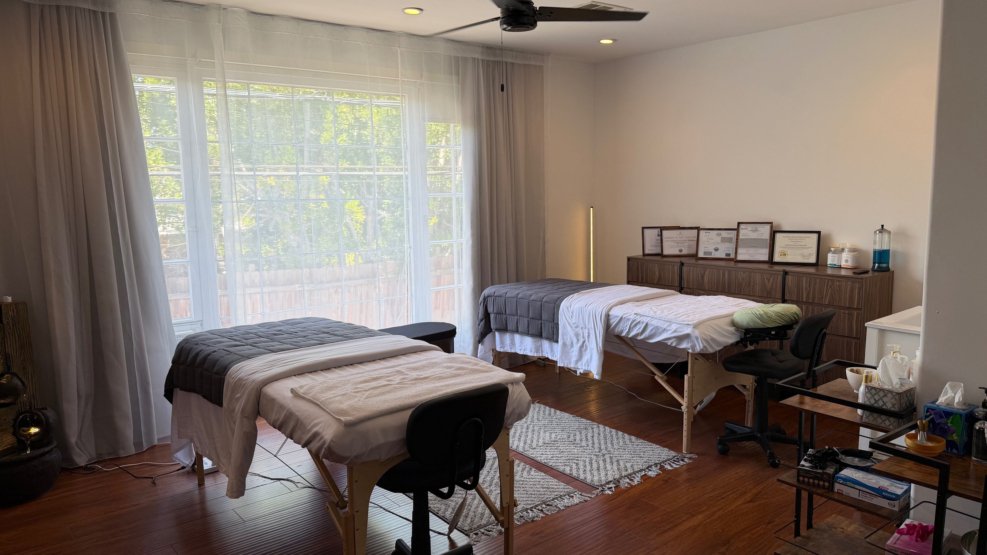 Relaxing treatment room at Face Studio LA in Los Angeles, California, US with two massage tables and certificates.