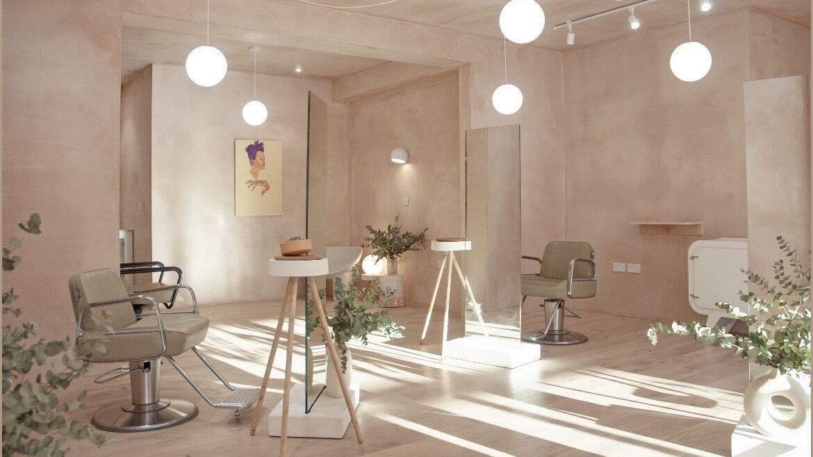 Modern interior of Ramona Hairdressing, London, England, GB, featuring stylish chairs and elegant decor.