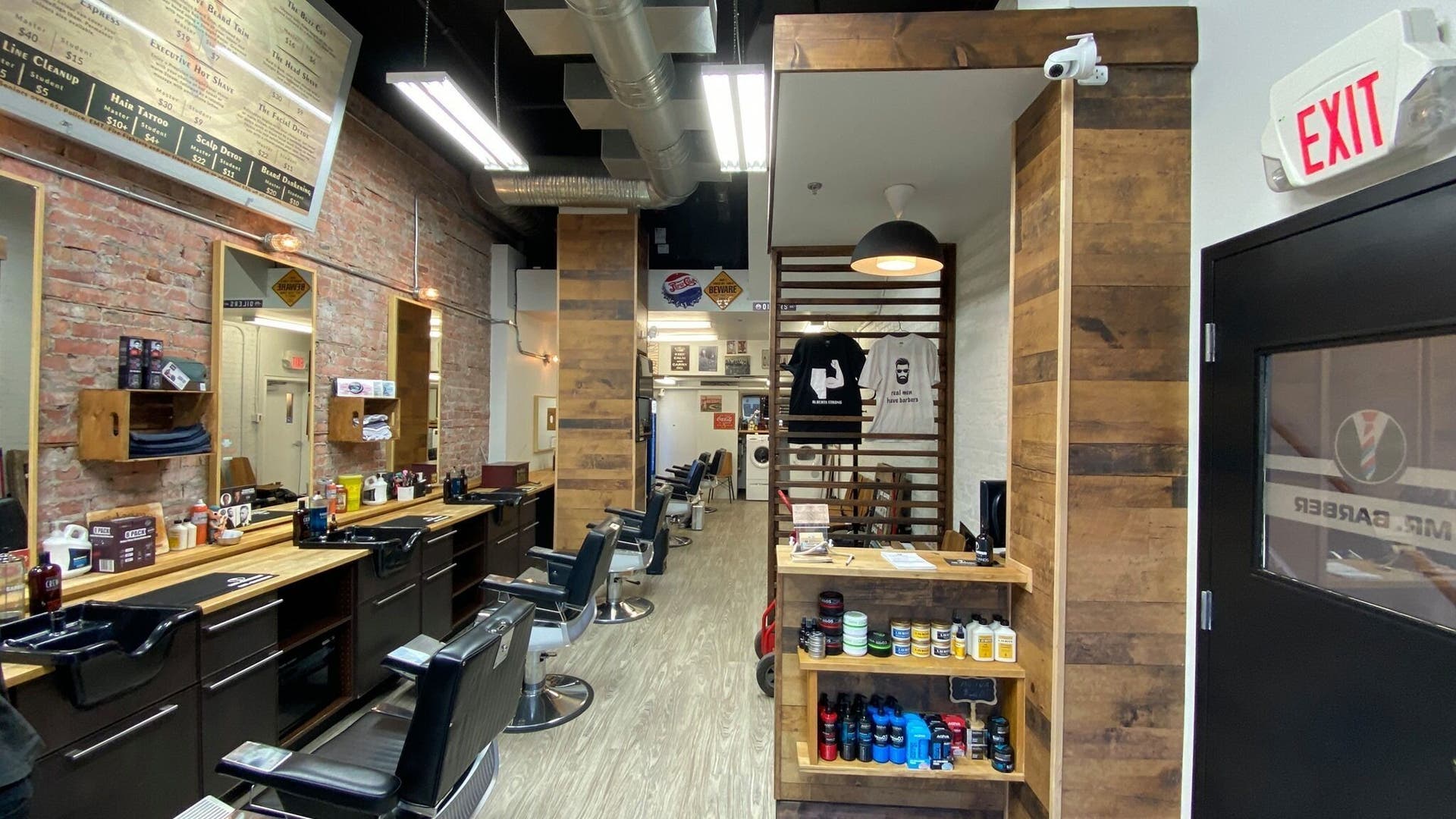 Interior of Mr. Barber - Downtown in Edmonton, Alberta, CA, featuring modern barber chairs and rustic decor.