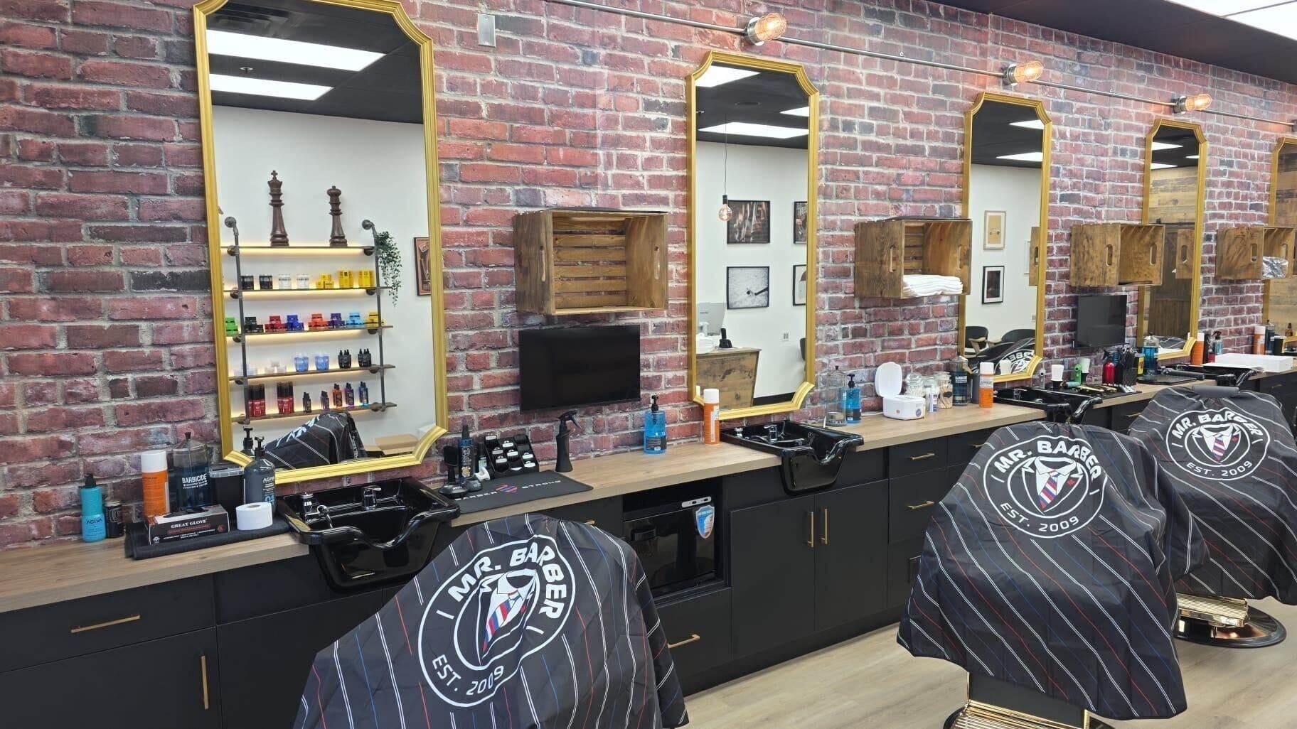 Elegant interior of Mr. Barber Deerfoot Meadows, Calgary, Alberta, CA with brick walls and styling stations.