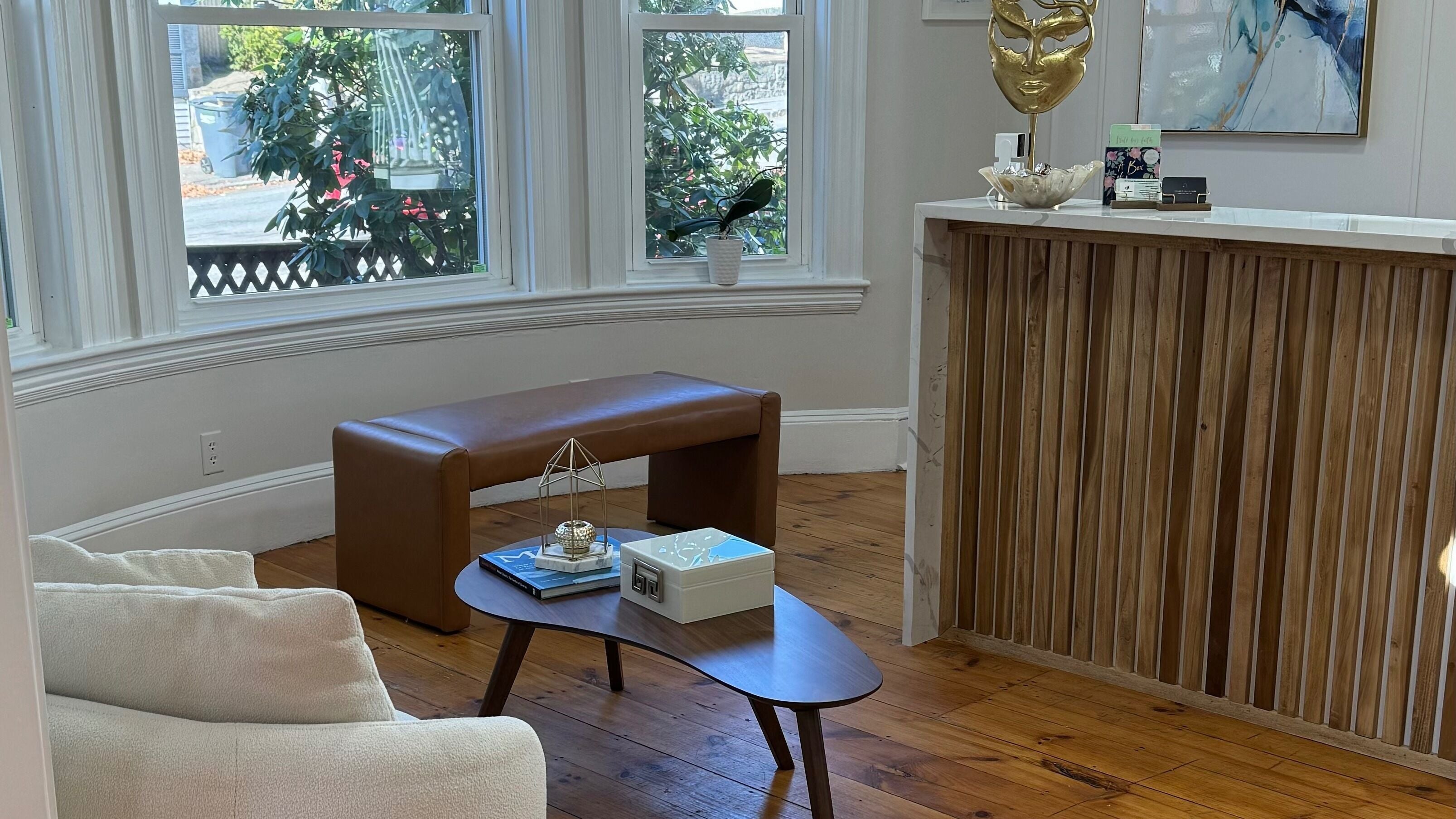 Cozy seating area at Sandra Faria Beauty, Hudson, Massachusetts, US with elegant wooden fixtures.