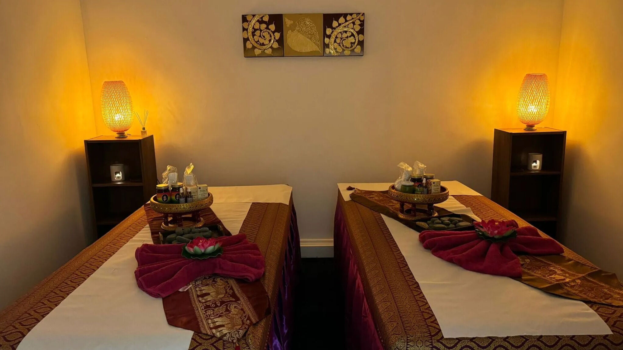 Relaxing massage room at Sawatdee Thai Therapy, Cardiff, Wales, GB, with warm lighting and elegant decor.