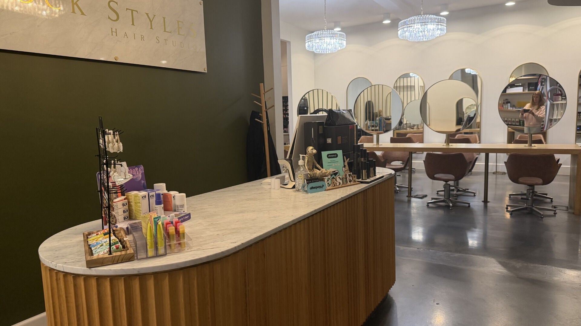 Modern salon interior at Hair By Maya, Melbourne, Victoria, AU with chic mirrors and cozy chairs.