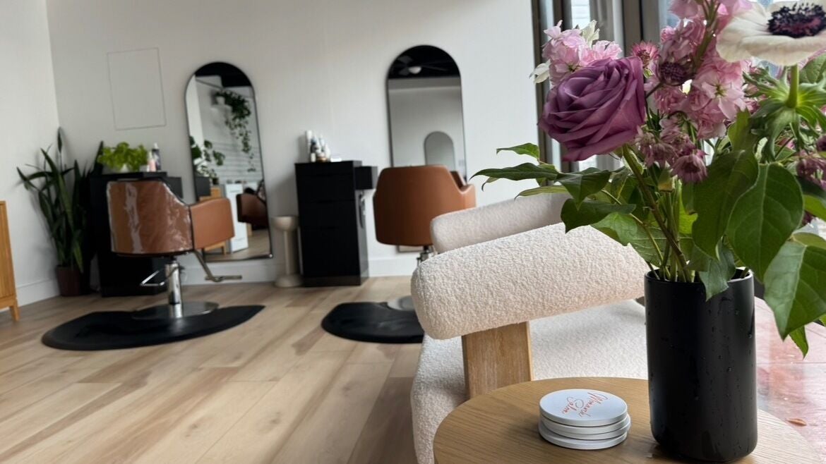 A chic setup at Monarch Salon on Union Street, San Francisco, California, US, featuring a stylish chair and fresh flowers.