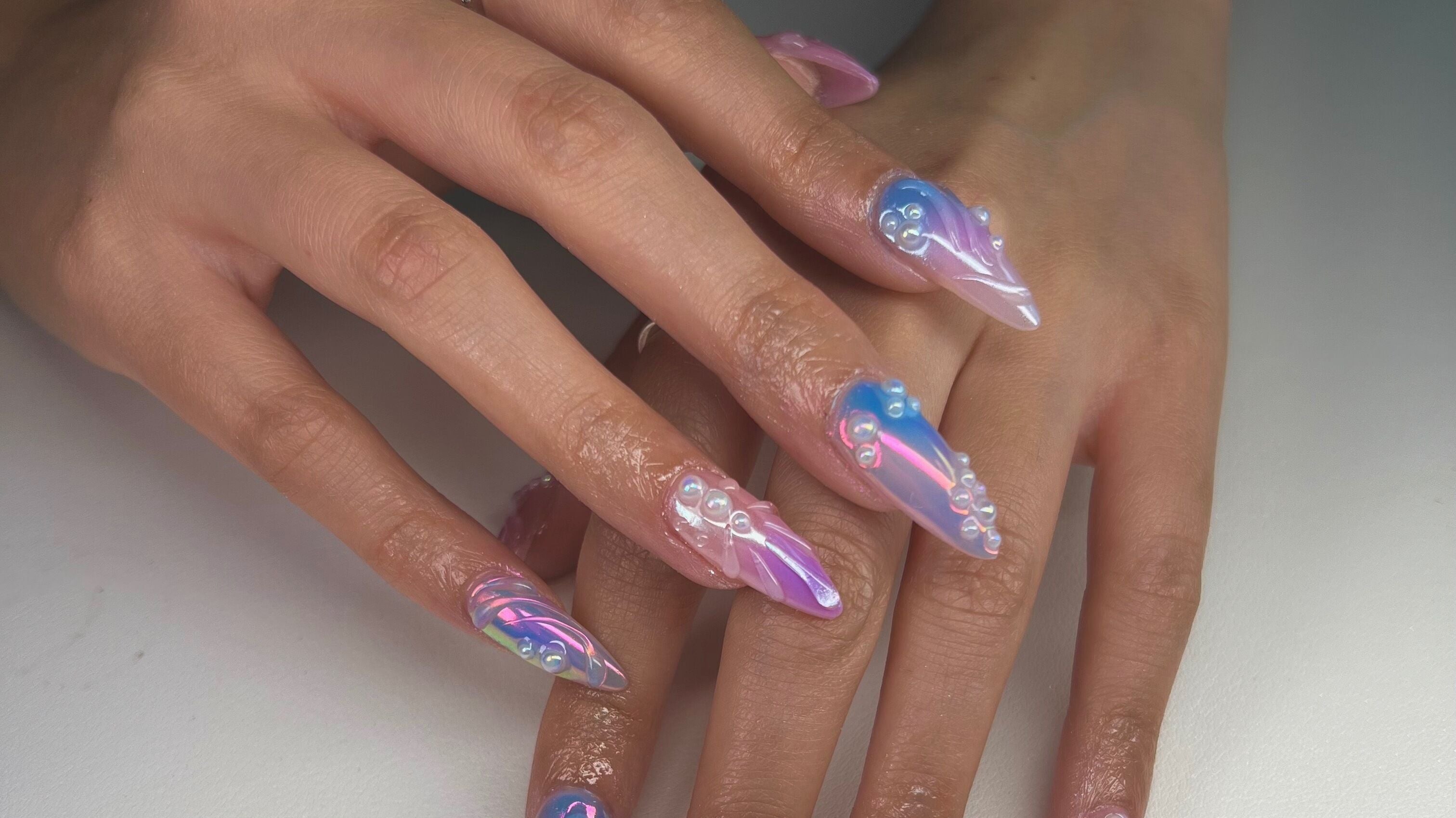 Glamorous pearl-accented nails by Nailzdidbycoco in Scottsdale, Arizona, US showcasing intricate 3D designs.
