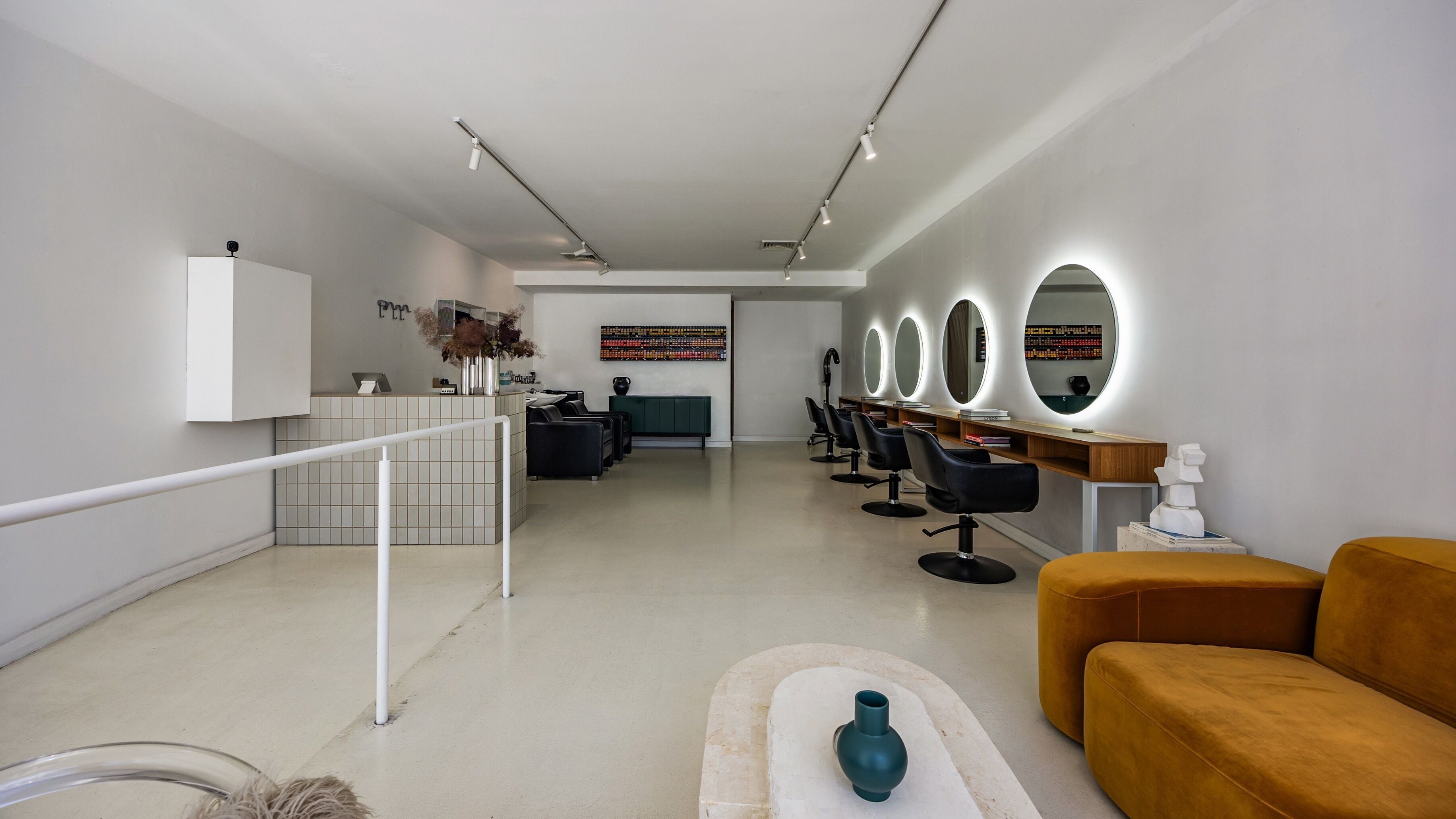 Chic interior of Waves Hair Studio in Melbourne, Victoria, AU, featuring modern styling chairs and decor.