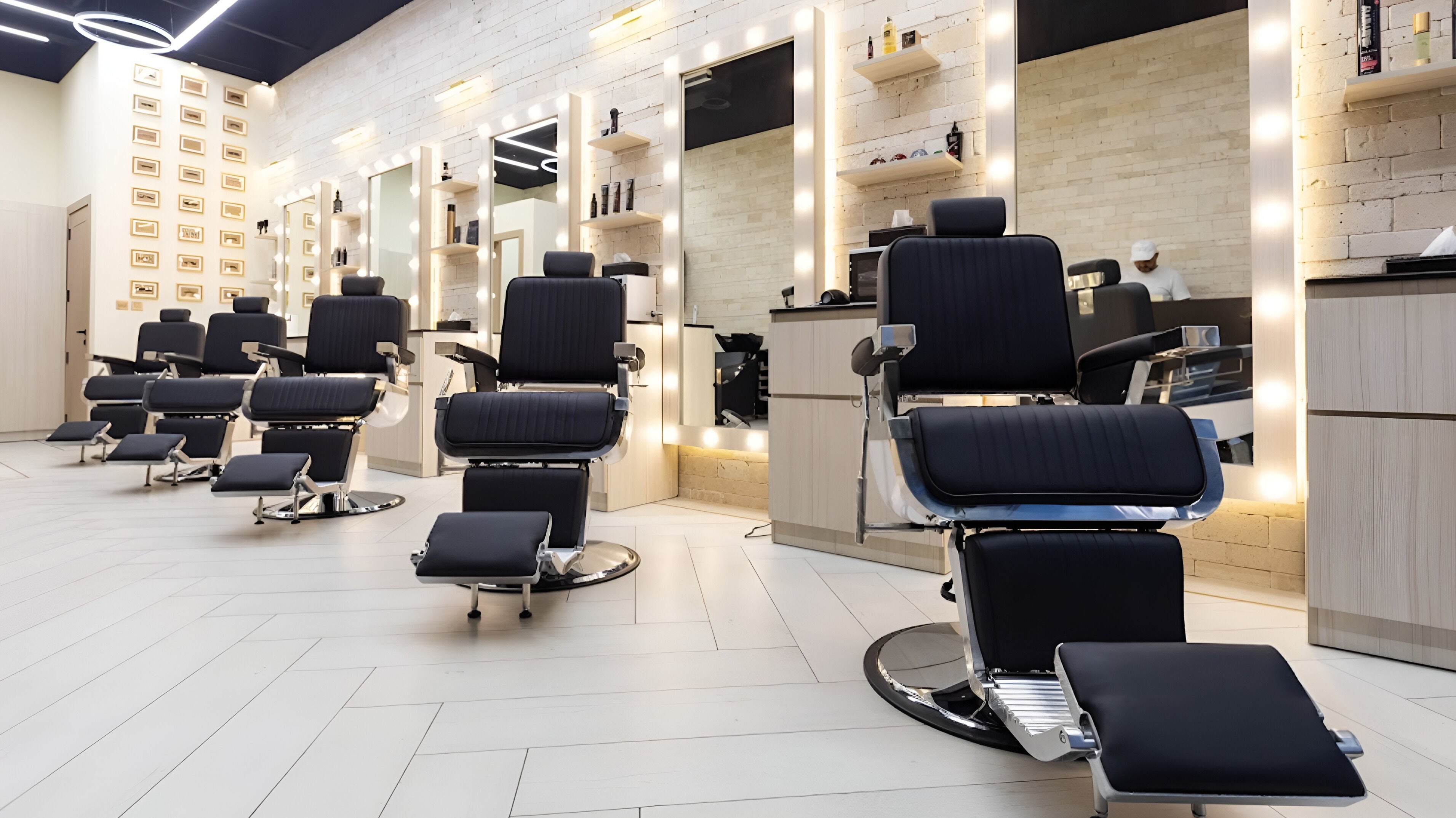 Modern interior of Tache Barbershop in دبي, دبي, AE featuring sleek barber chairs and illuminated mirrors.