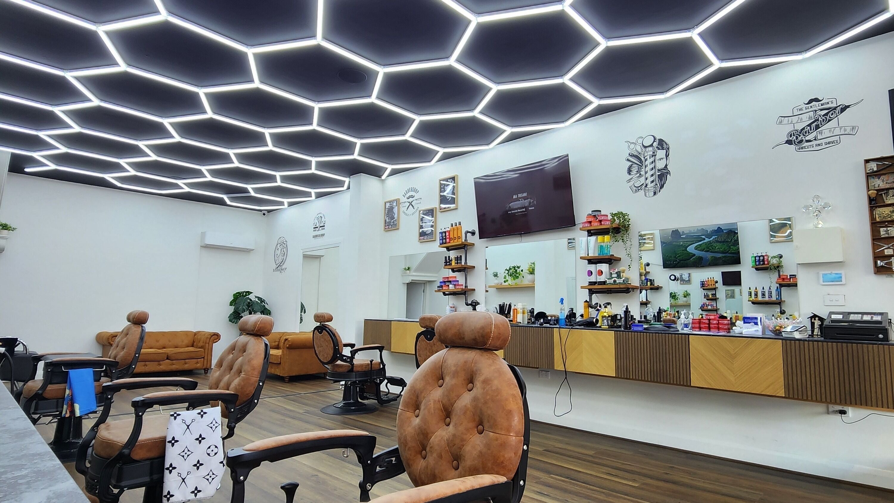 Sleek interior of Essendon Fresh Fades barbershop in Melbourne, Victoria, AU with modern decor and seating.