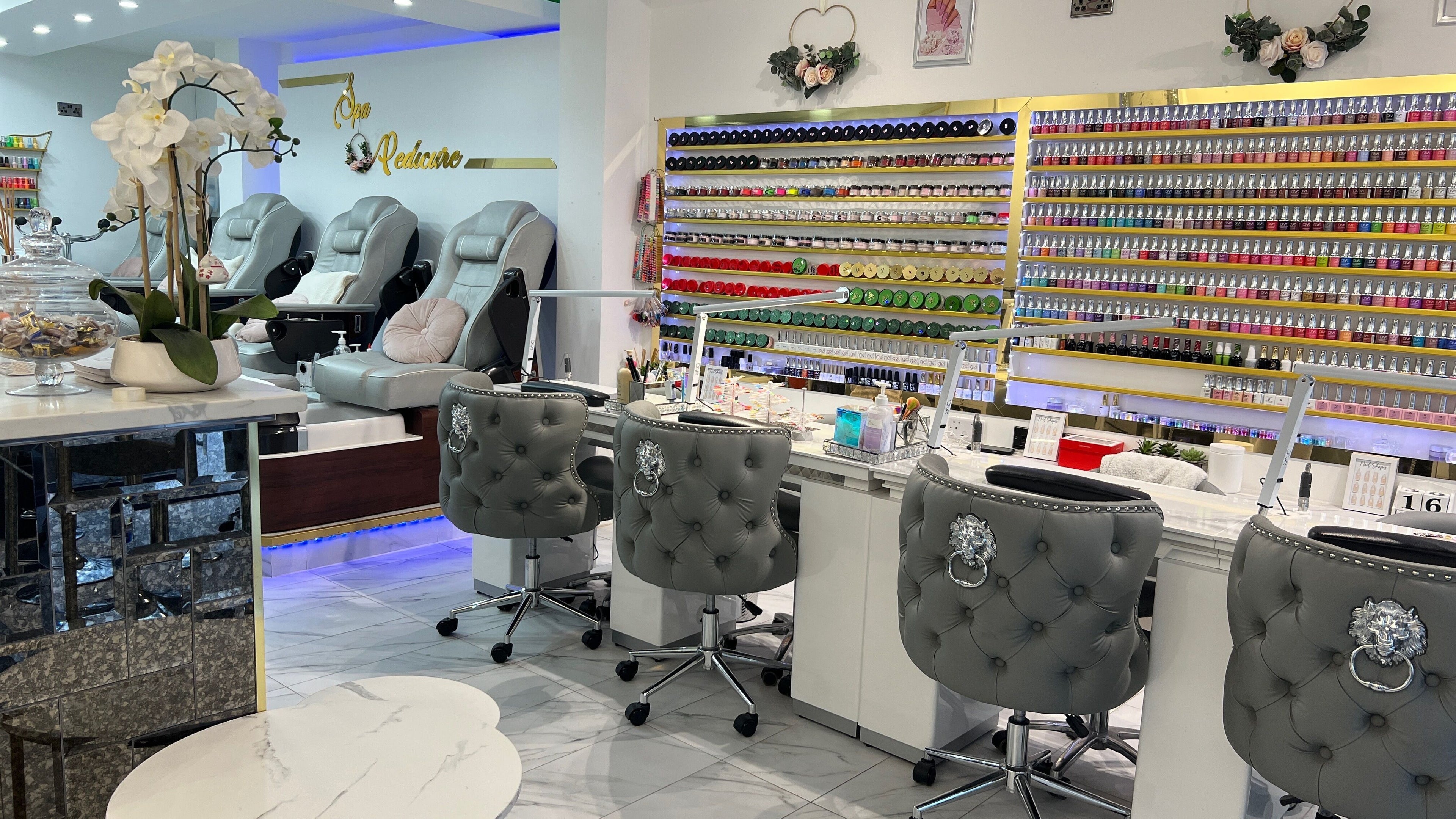 Elegant nail spa at Amore Shoreditch, London, England, GB, with plush chairs and a vast nail polish selection.