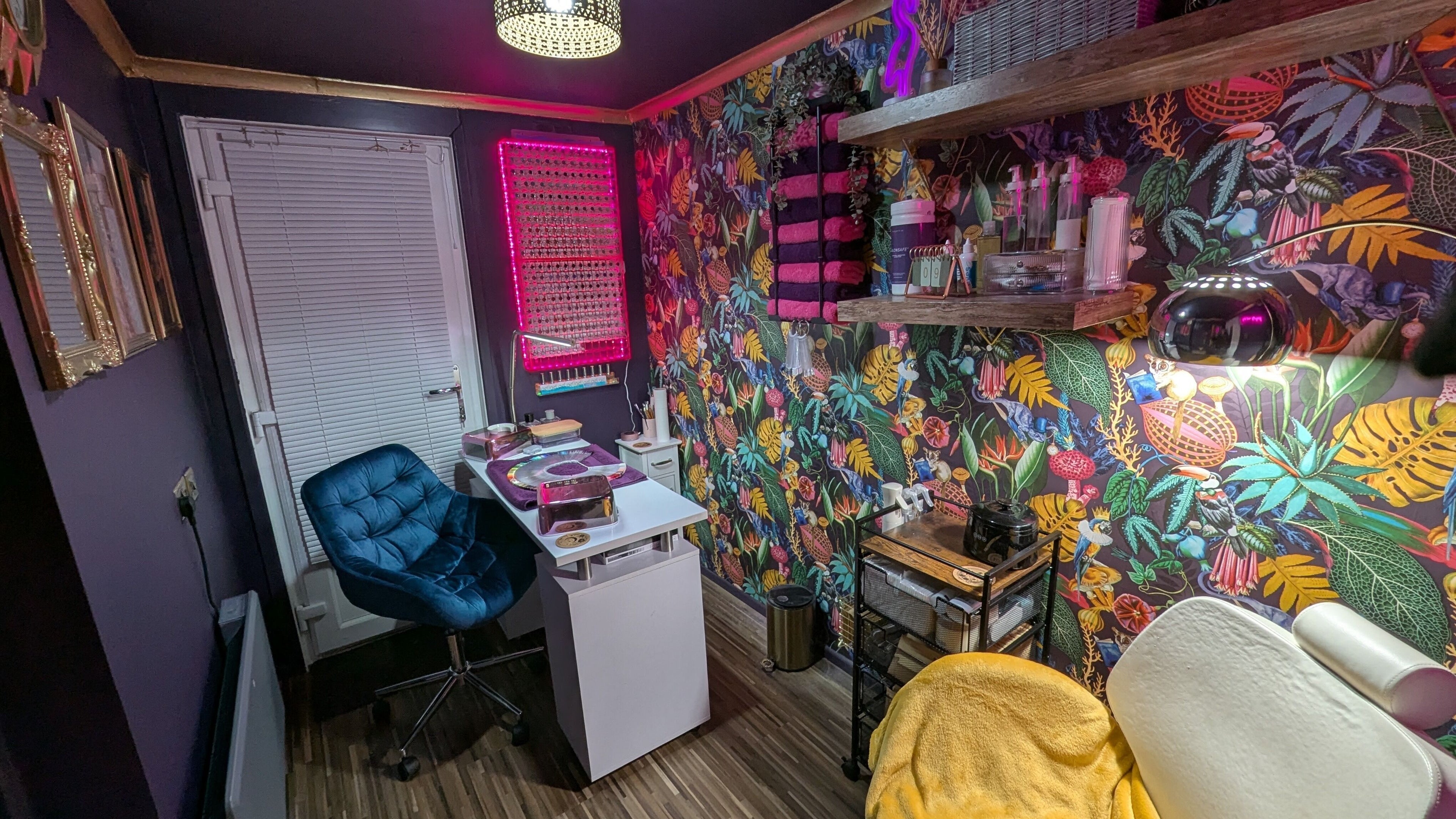 Vibrant nail studio at The Nailbox Netherton, Dudley, England, GB with colorful floral wallpaper.