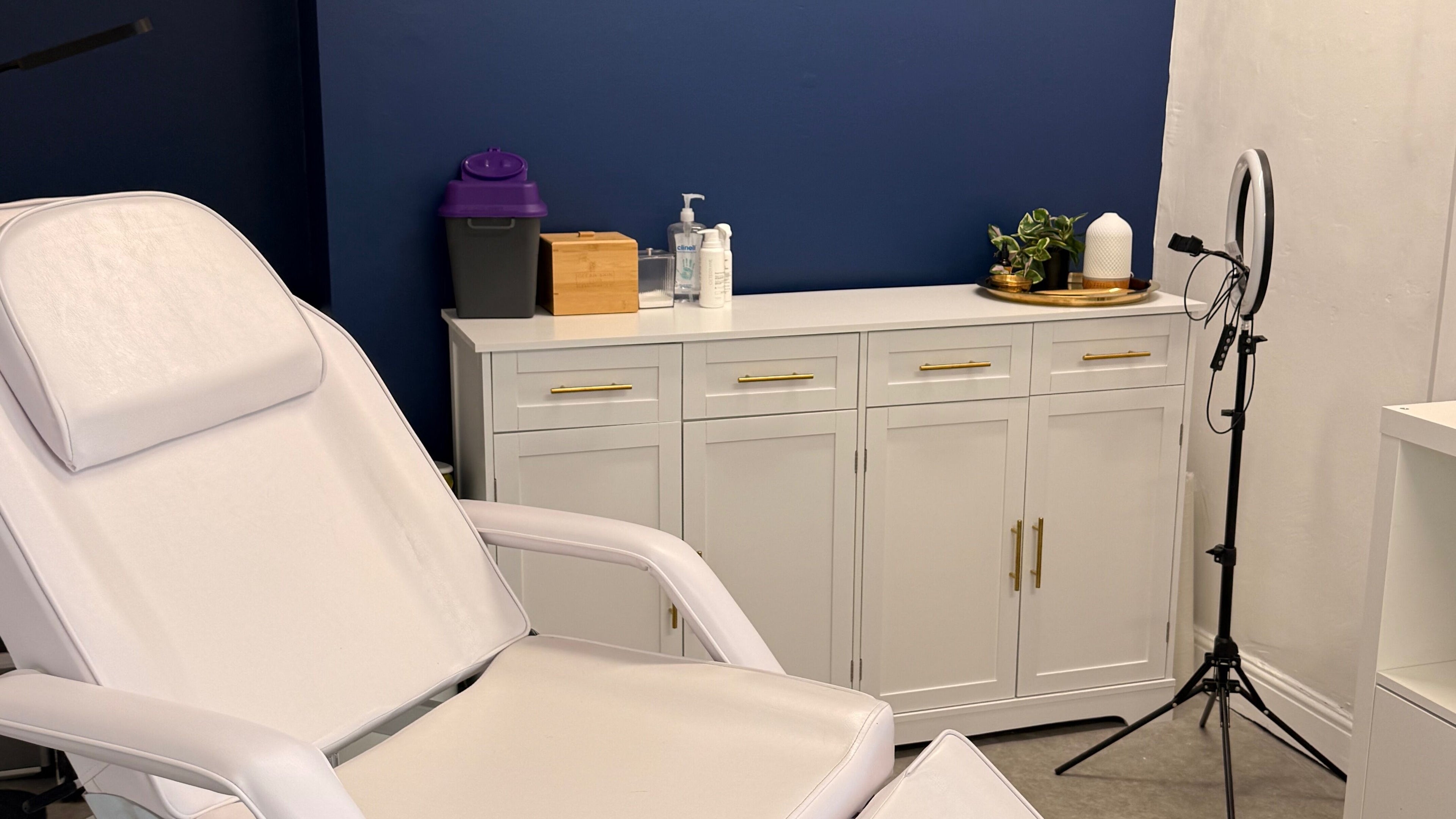 Tranquil treatment room at Cardiff Aesthetics, Cardiff, Wales, GB with a white chair and stylish decor.