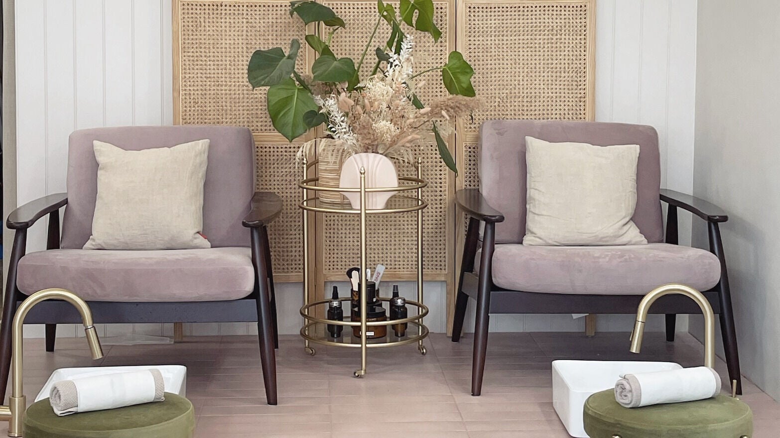 Pampering lounge at L&W Brixton | BIAB Nails & Brows, London, England. Cozy chairs with plants and pedicure setup.