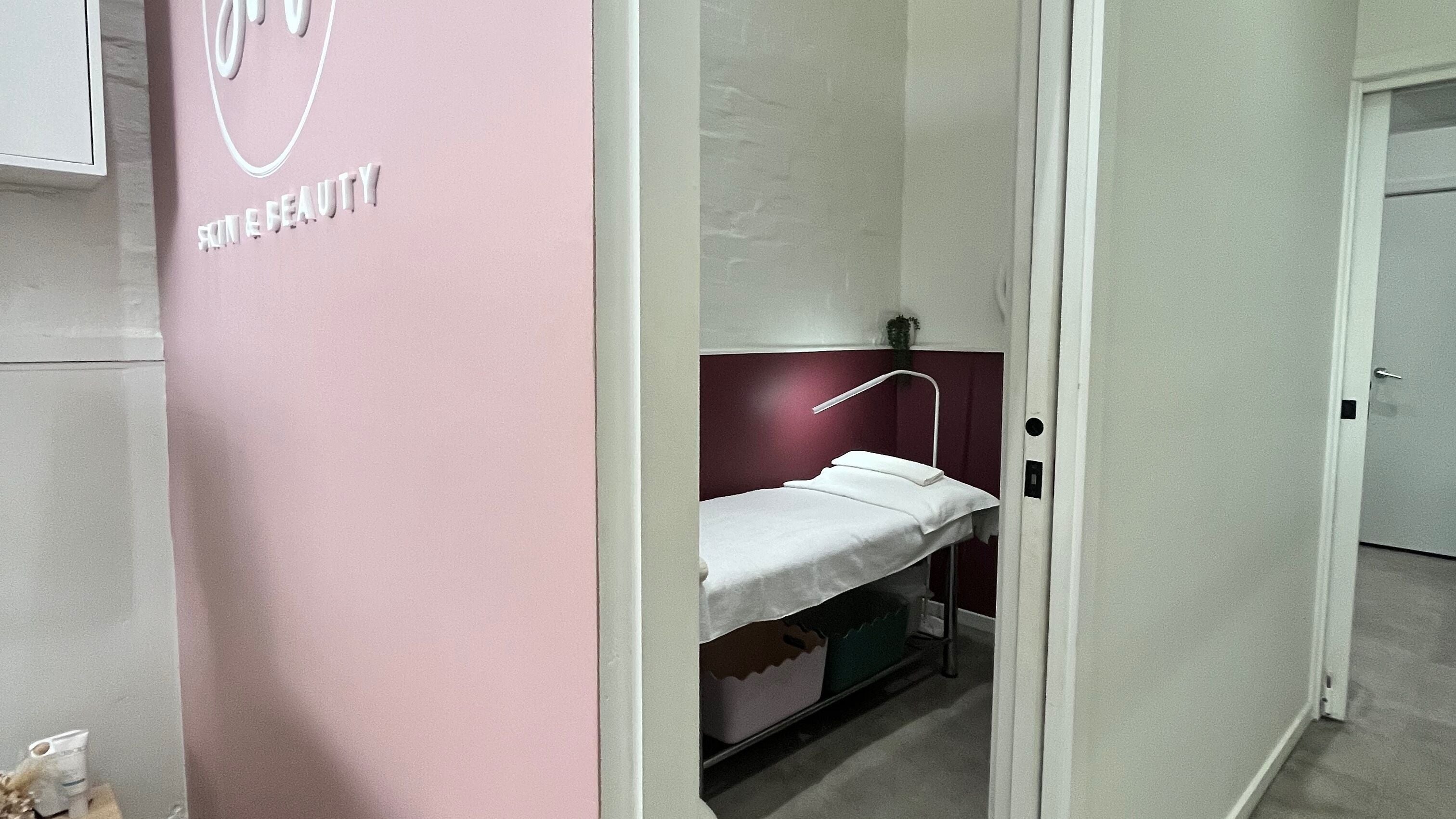 Relaxing spa room at Her Beauty Curator in Melbourne, Victoria, AU, featuring a cozy massage bed.