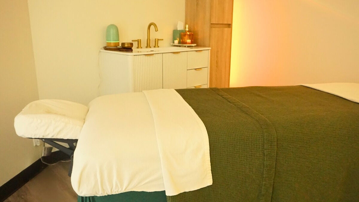 Tranquil massage room at Amita Luna Perinatal, Merrick, New York, US, featuring plush bed and soothing decor.