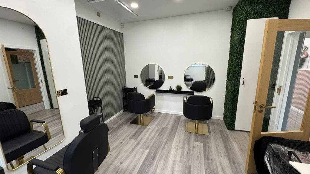 Modern beauty salon interior at The R.E.H.A.B Limited, Hornchurch, England, GB featuring elegant chairs and mirrors.