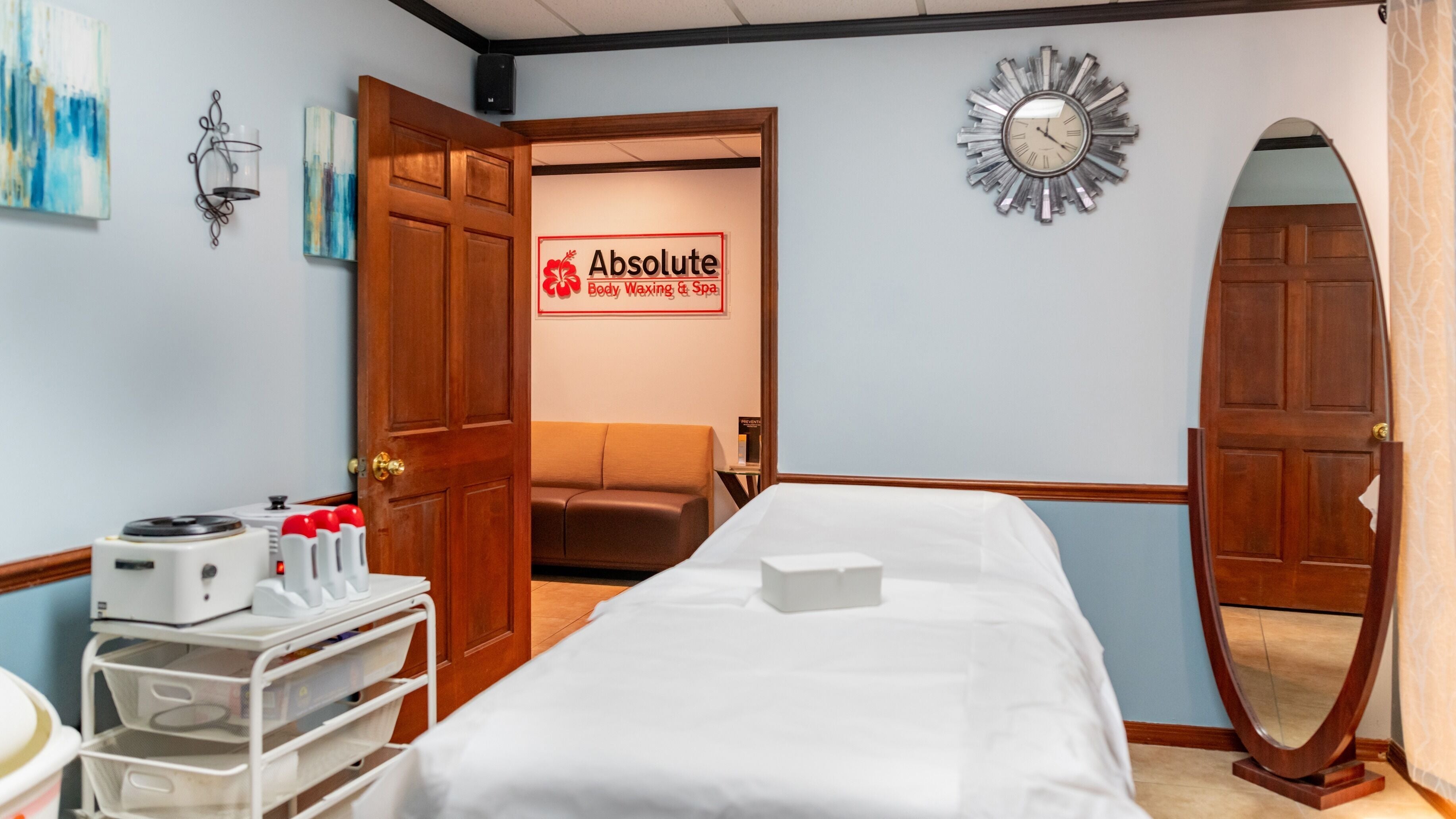 Tranquil spa room at Absolute Body Waxing and Spa, Winter Park, Florida, US with massage table and elegant decor.