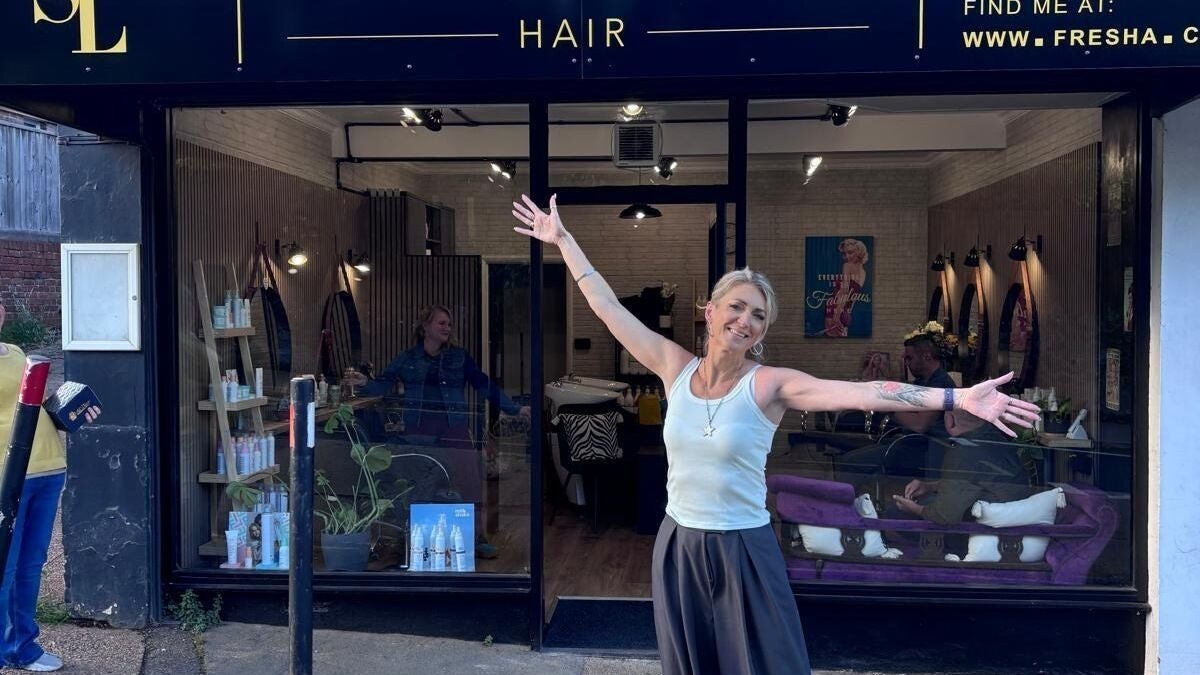 Sophia Lewis Hair in Exeter, England, GB: stylist joyfully greeting clients at salon entrance.