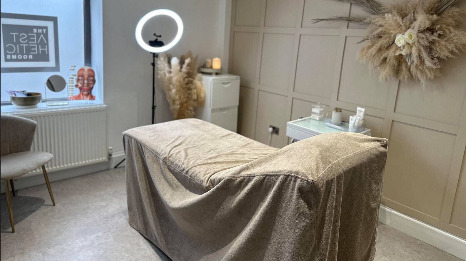 Elegant treatment room at The Aesthetic Rooms, Rochdale, England, GB, featuring a plush bed and chic decor.