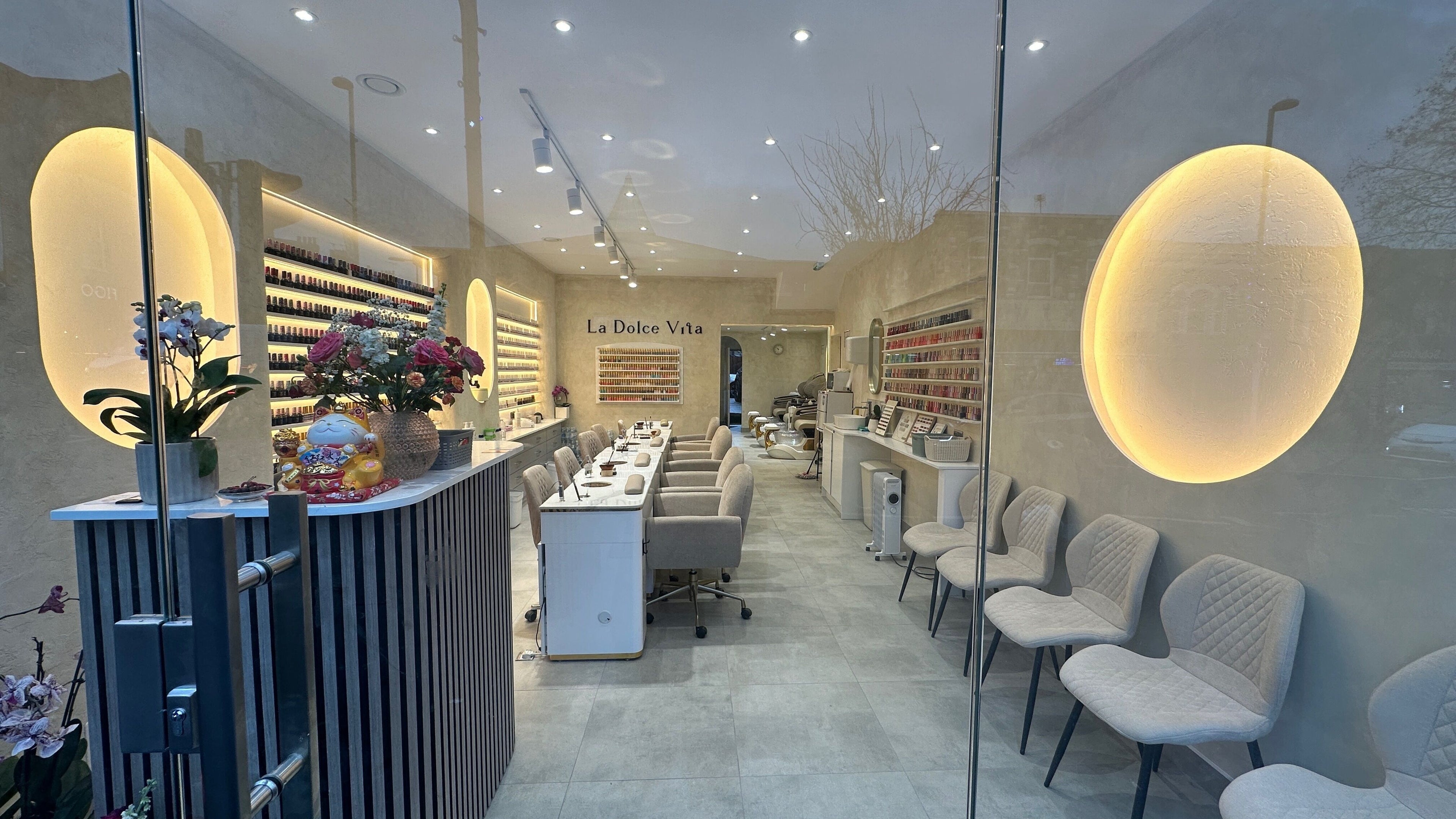 Interior of CN Nails Studio in London, England, GB, showcasing chic seating and nail polish displays.