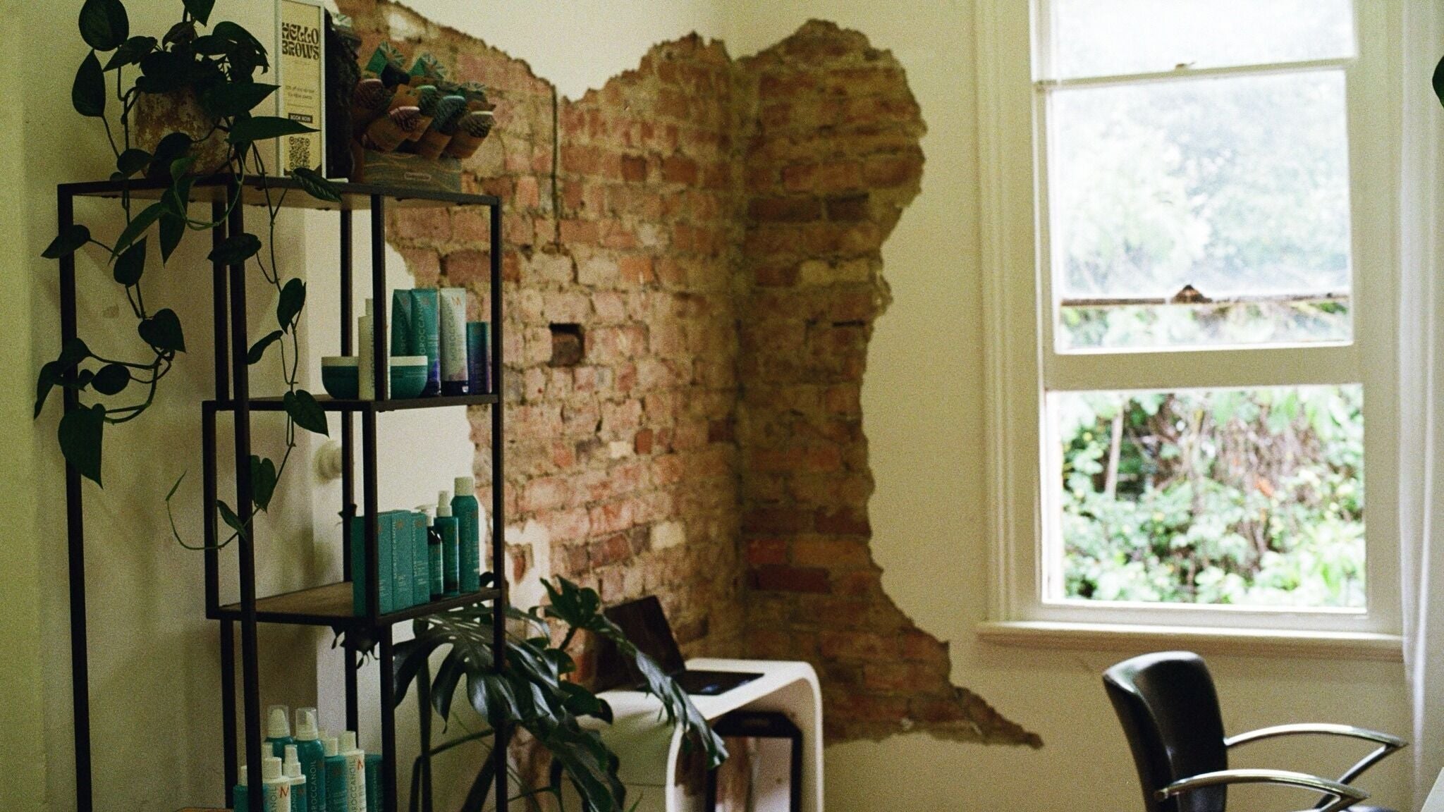 Chic brick wall and products at Anthony Pineda Hair, Prahran, Victoria, AU, blending urban style with nature.