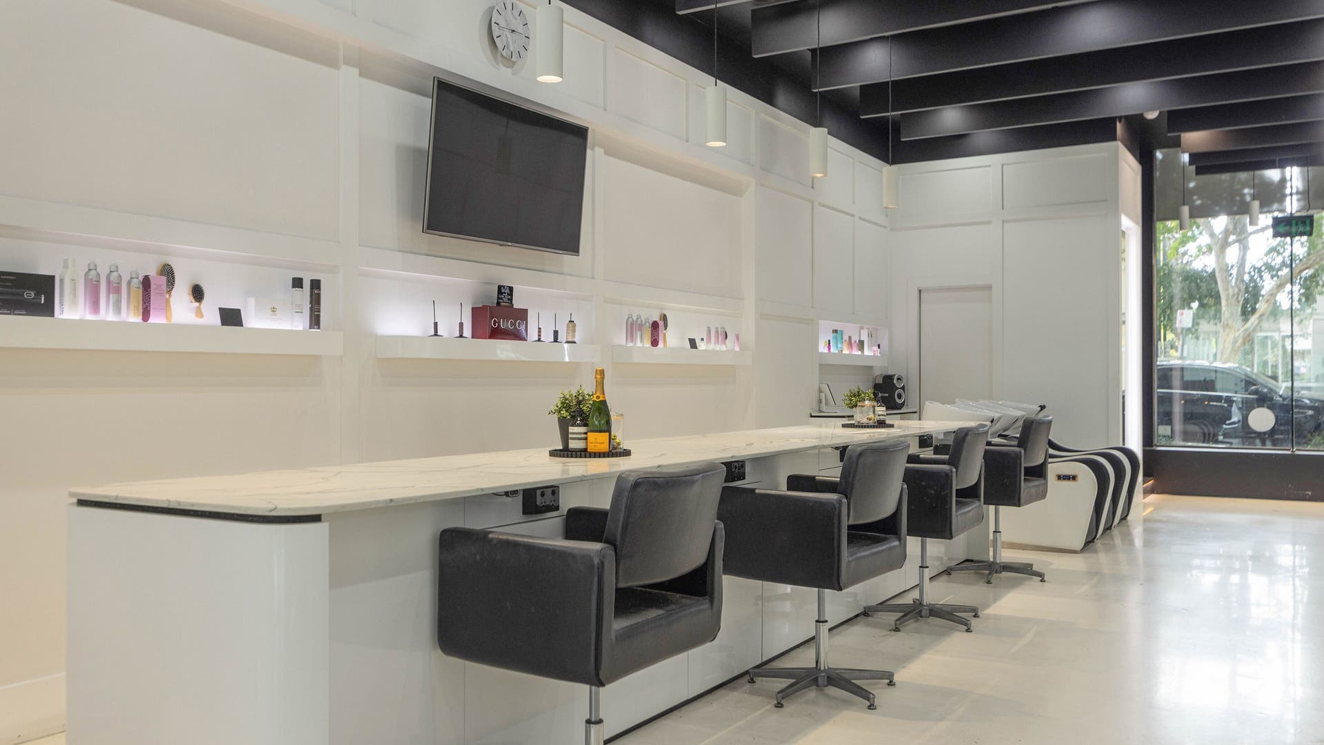 Modern salon interior at Vixen Hair Extensions Pty Ltd, Fortitude Valley, Queensland, AU, showcasing stylish workstations.