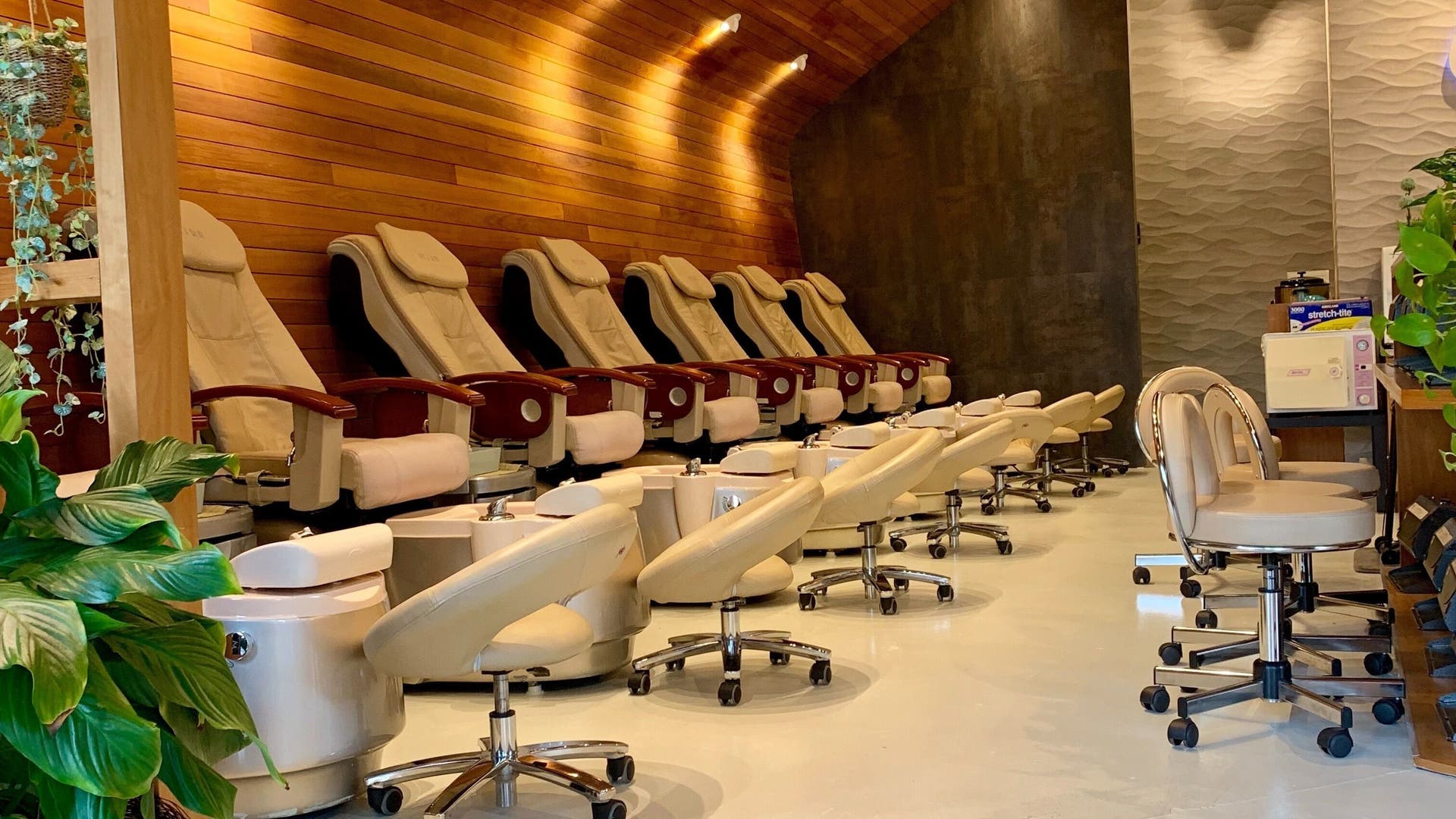 Splendid Nail and Spa's luxurious pedicure lounge at Fort Lee, New Jersey, US, featuring plush seating and decor.