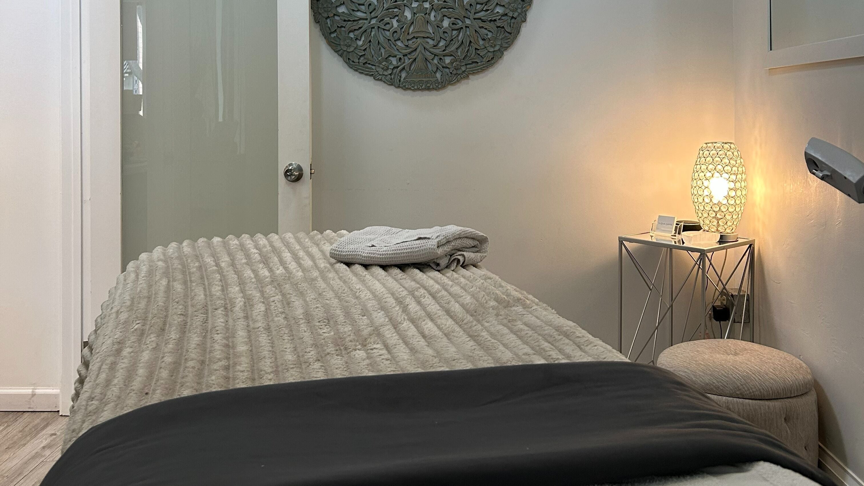 Tranquil massage room at Elisha Marie Skin & Body in Palo Alto, California, US, featuring ambient lighting.