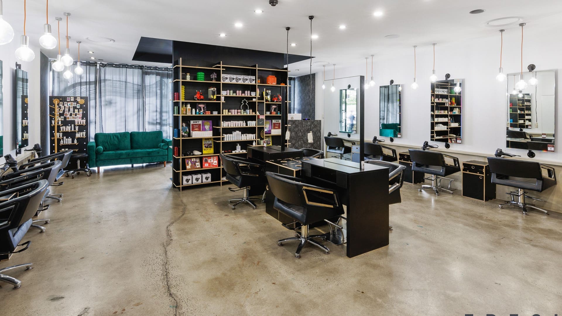 Modern salon interior at Lunatic Fringe in Clayfield, Queensland, AU, featuring styling stations and sleek decor.