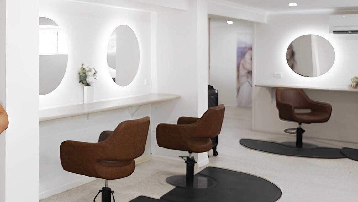 Stylish interior of Vanity Hair Lounge, Bundamba, Queensland, AU, featuring modern salon chairs and elegant mirrors.
