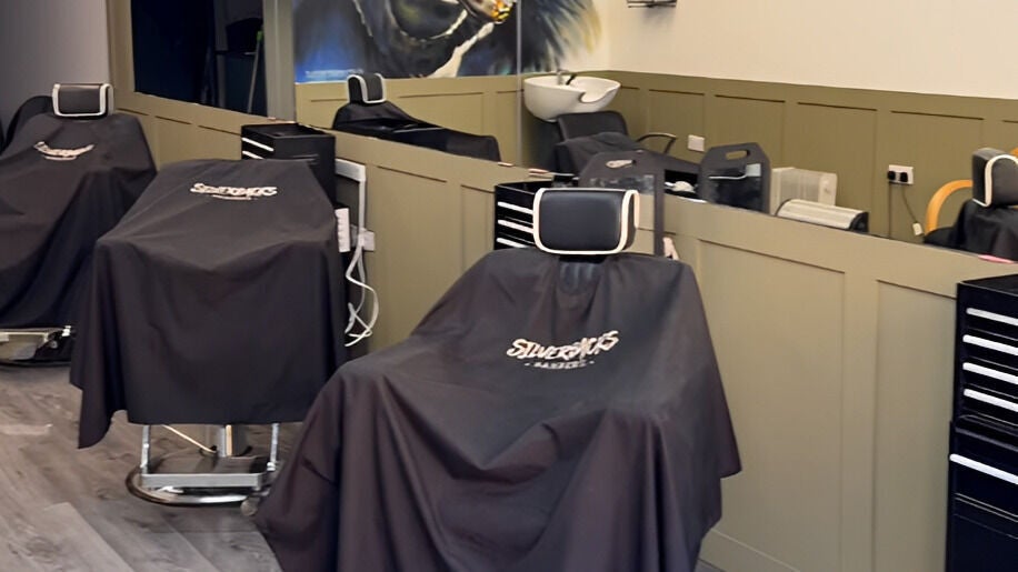 Interior of Silverbacks Barbers in Glasgow, Scotland, GB, featuring modern barber chairs and equipment.