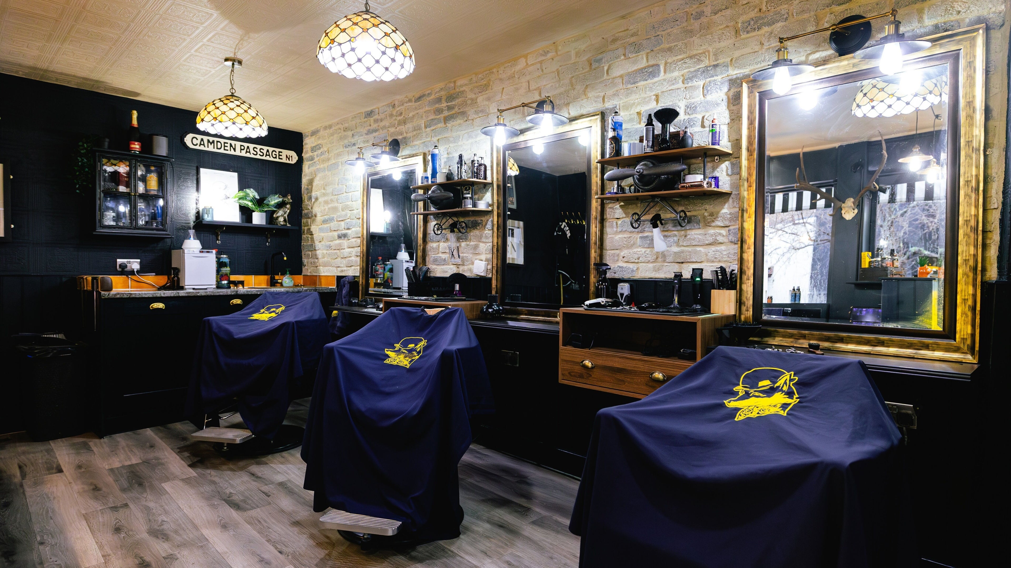 Interior view of Barber Smiths Islington, London, England, GB showcasing stylish barber chairs and decor.
