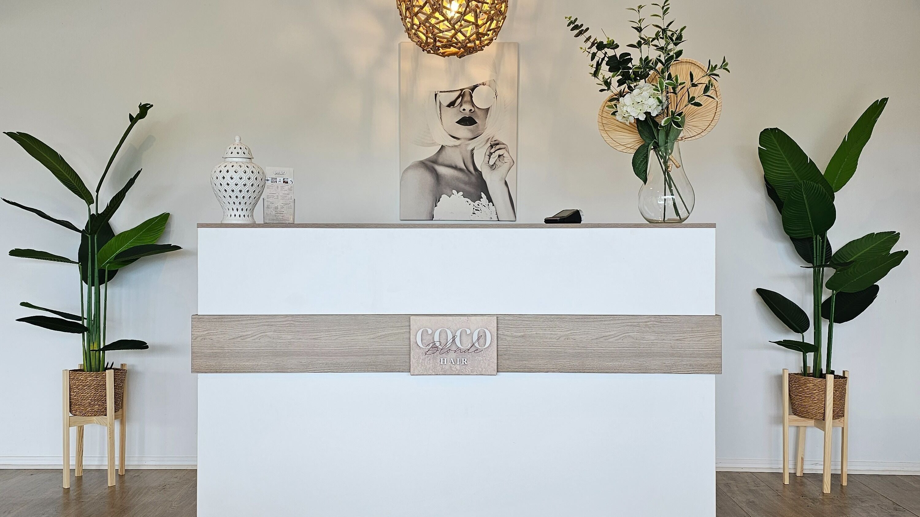 Modern reception at Coco Blonde Hair, Southport, Queensland, AU with elegant decor and plants.