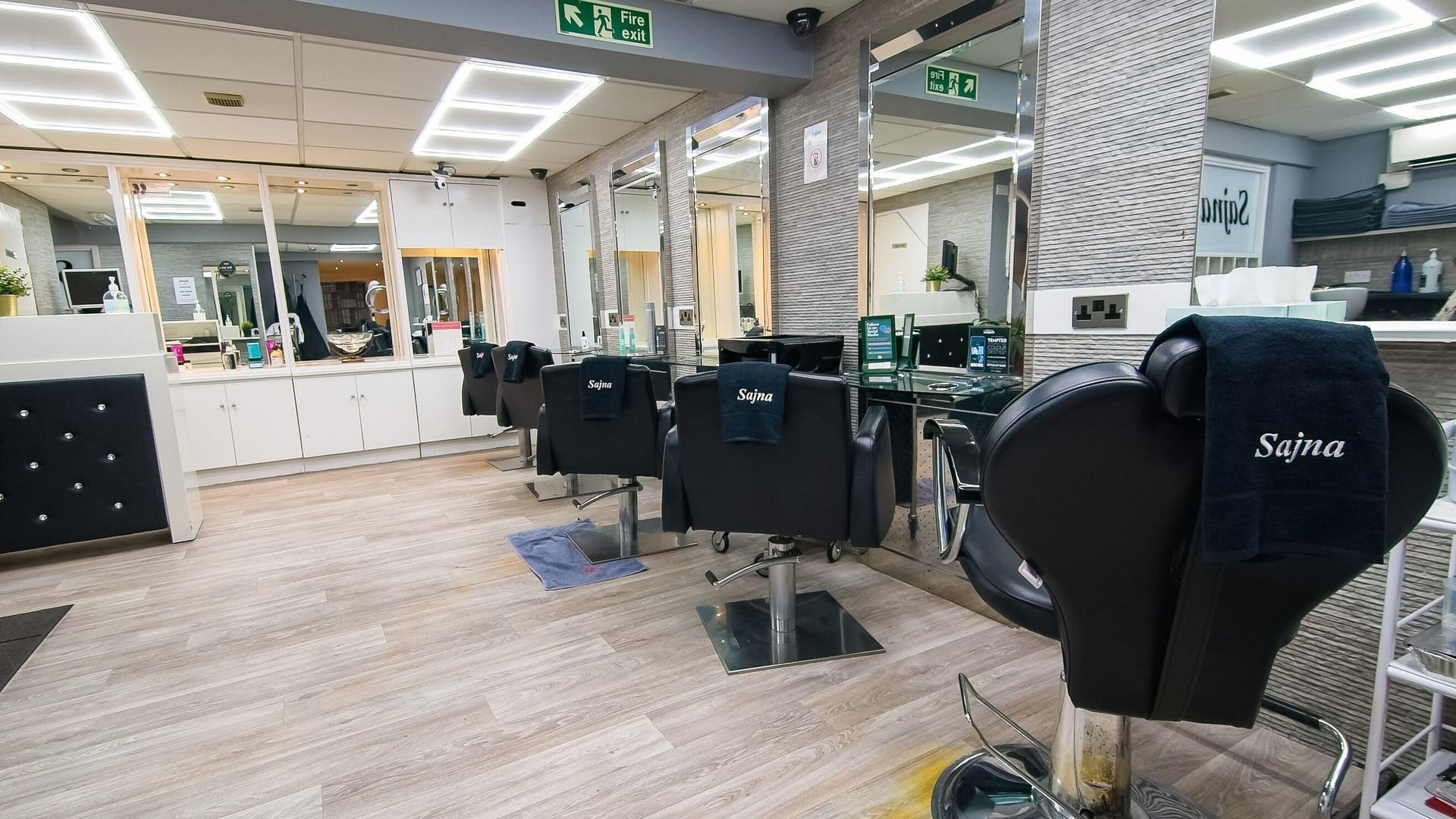 Interior of Sajna Hair and Beauty Ladies Only - Tooting, showcasing sleek styling chairs in London, England, GB.