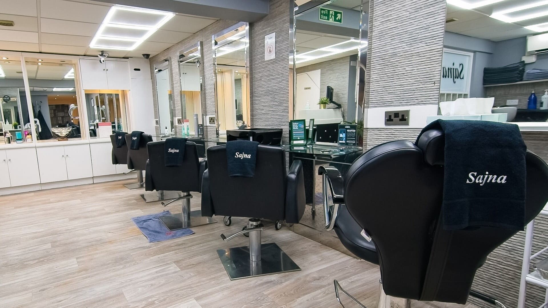 Modern salon interior at Sajna Hair and Beauty 234A Upper Tooting, London, England, GB with stylish chairs.