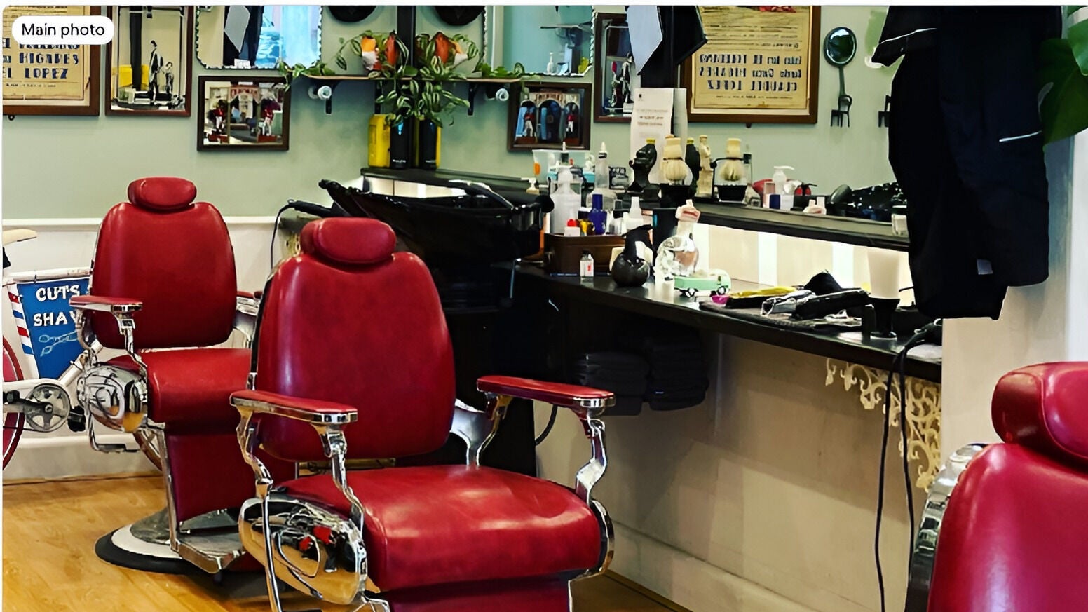 Classic red chairs at Le Barbier d’ Elwood, Melbourne, Victoria, AU, showcasing stylish barber ambiance.