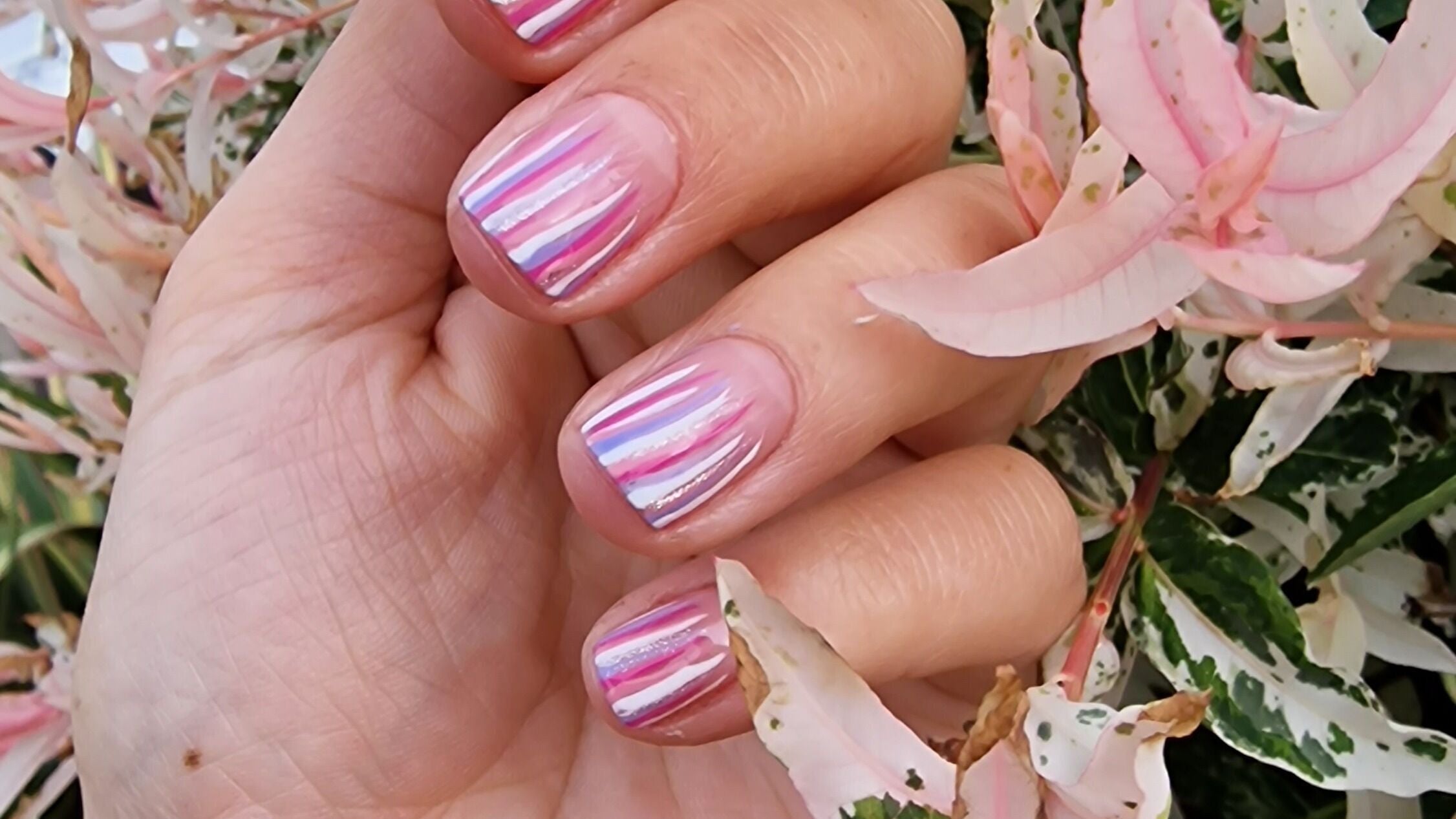 Vibrant nail art with pink stripes at Beauty at The Frank Lee, Cambridge, England, GB.