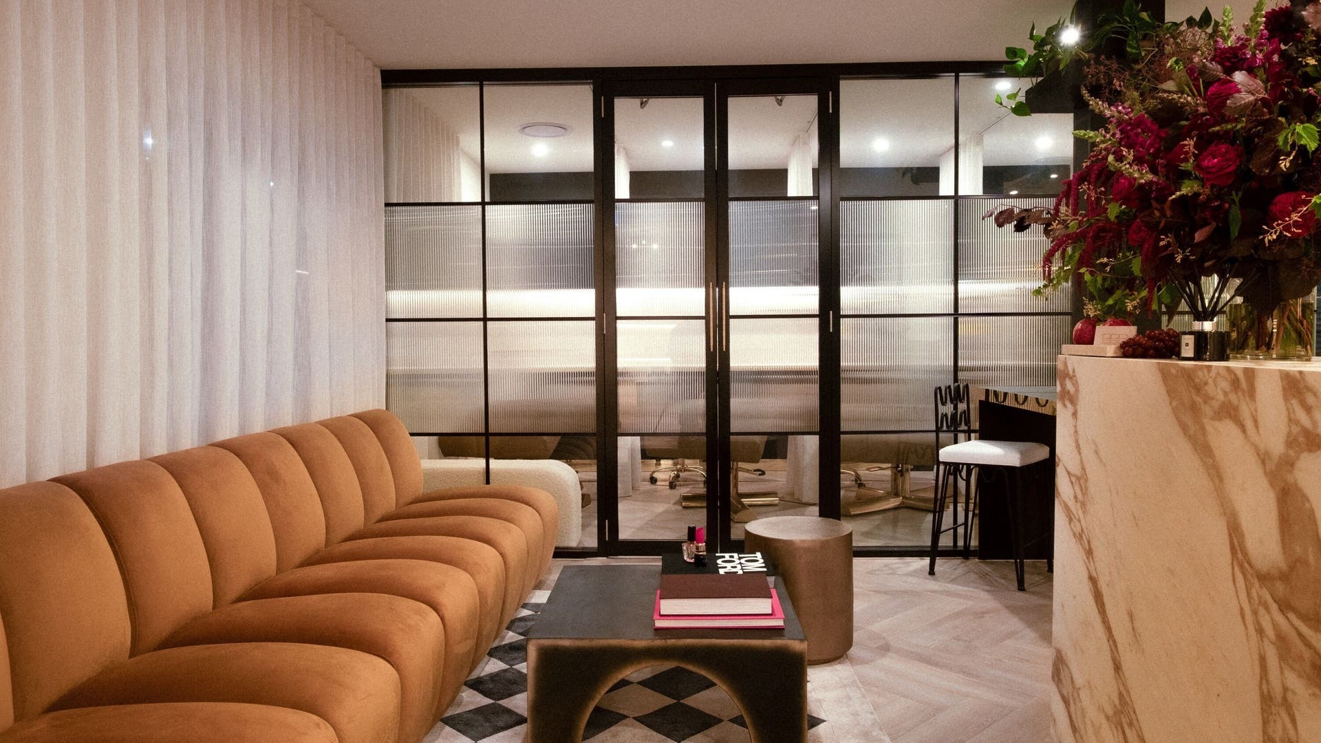 Stylish lounge area at Brisbane Beauty Bar, Newstead, Queensland, AU with plush seating and chic decor.