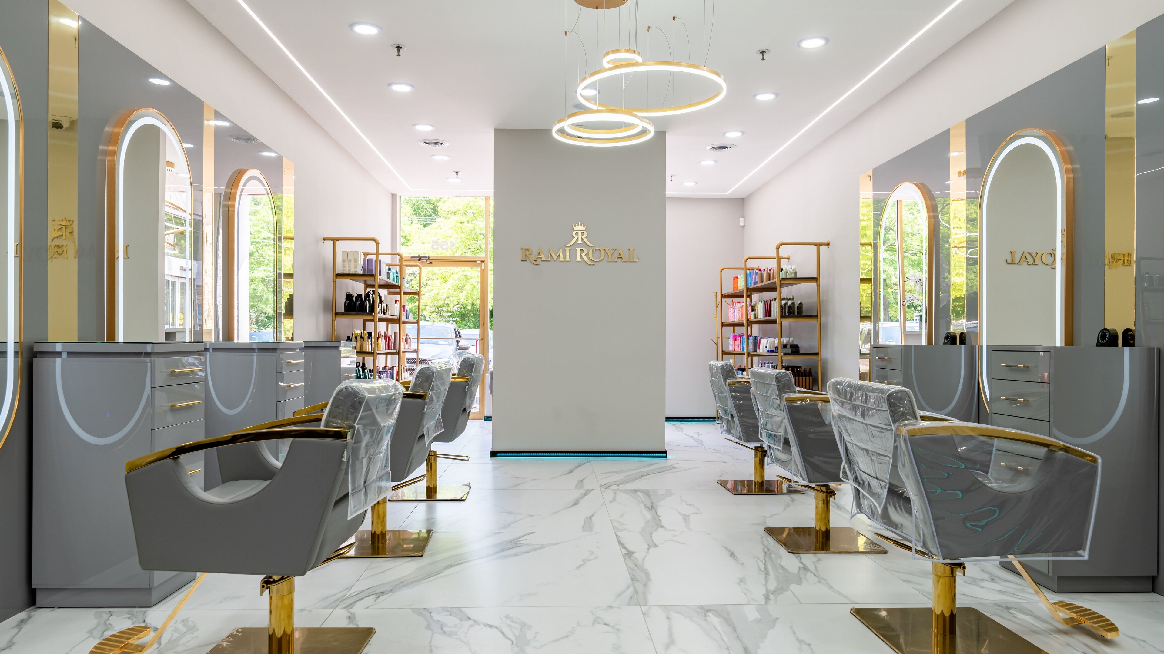 Elegant interior of Rami Royal Hair Salon in Oyster Bay, New York, US with modern decor and styling chairs.