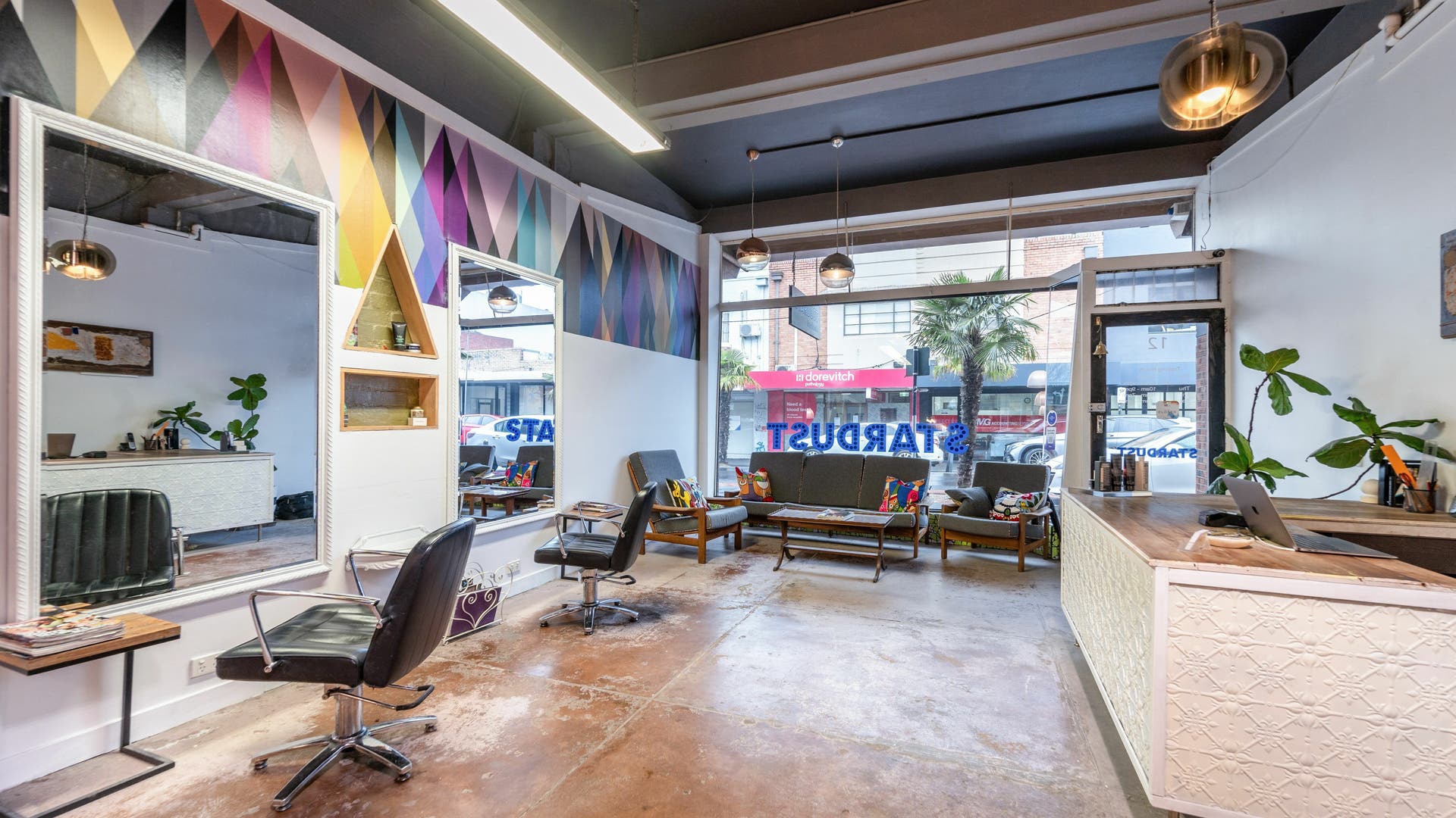 Chic interior of Stardust Hair Studio in Melbourne, Victoria, AU, featuring modern decor and colorful accents.