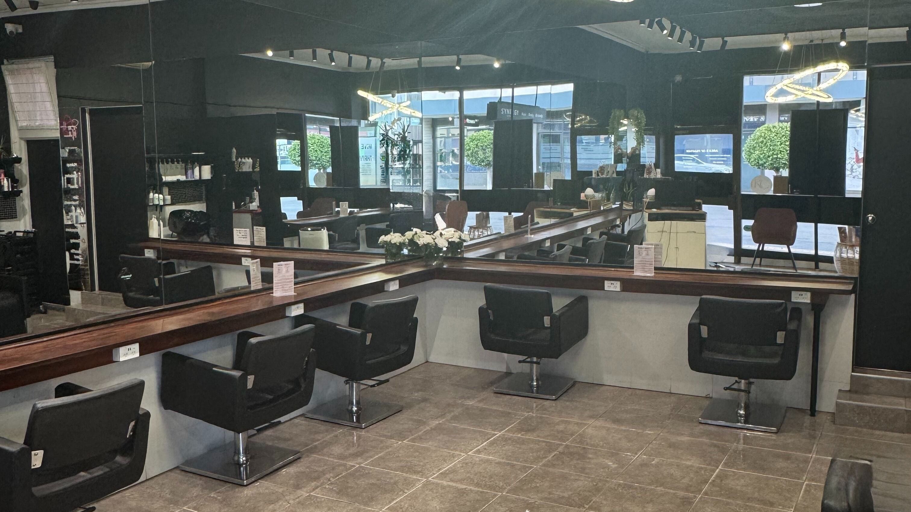 Modern salon interior at Synergy Melbourne, Bentleigh East, Victoria, AU with stylish workstations and polished decor.